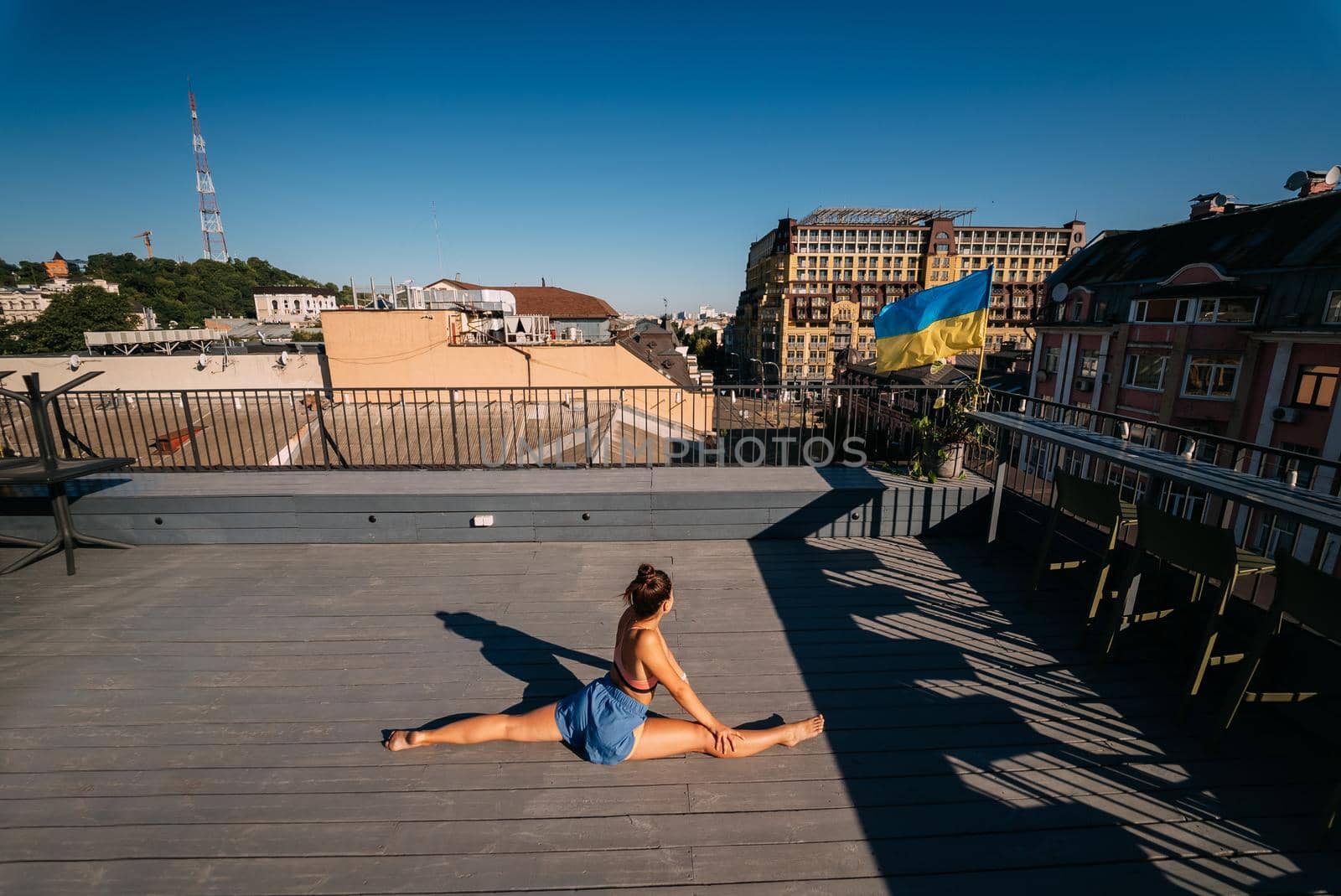 Young woman practicing yoga on the roof