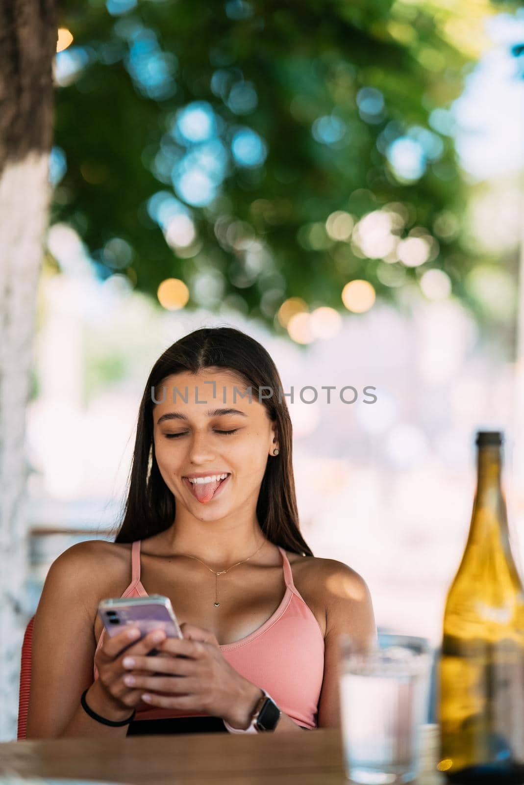 Photo of charming pretty young lady communicating modern gadget smiling outside urban city street