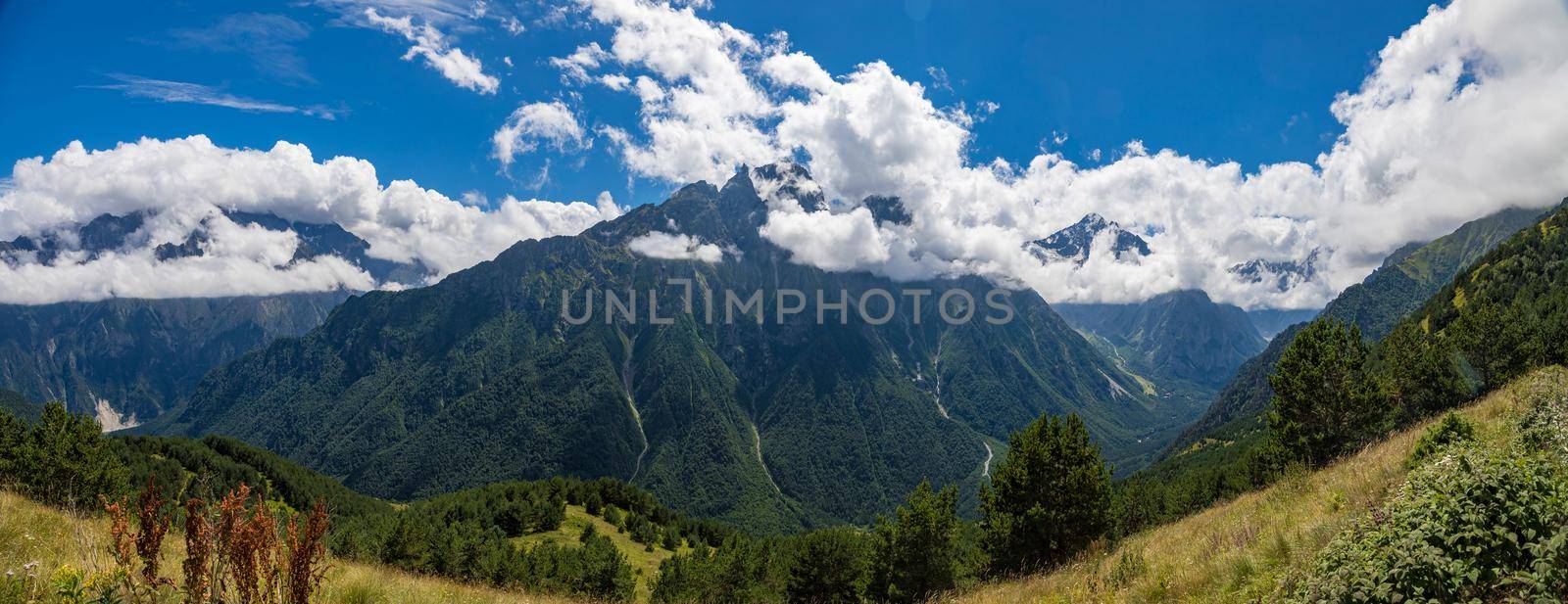 Panorama of mountains with beautiful clouds and waterfalls in North Ossetia