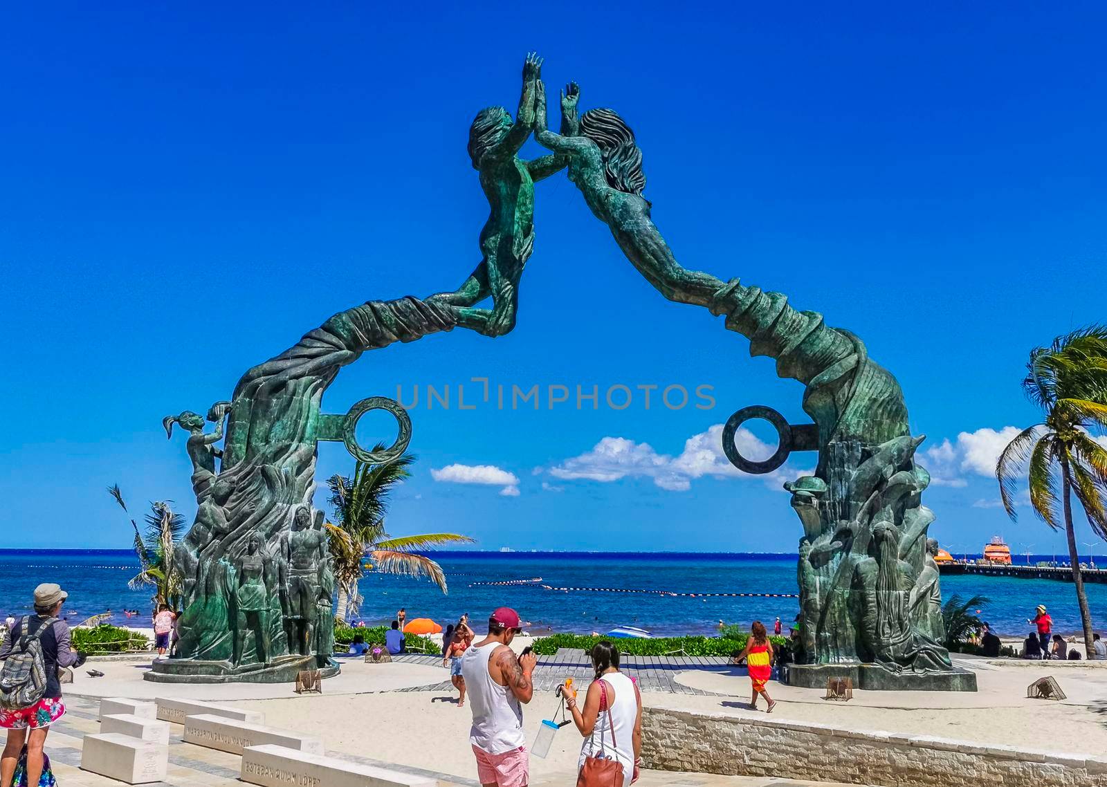 Playa del Carmen Mexico 14. May 2022 The ancient architecture of the Portal Maya in the Fundadores park with blue sky and turquoise seascape and beach panorama in Playa del Carmen Quintana Roo Mexico.