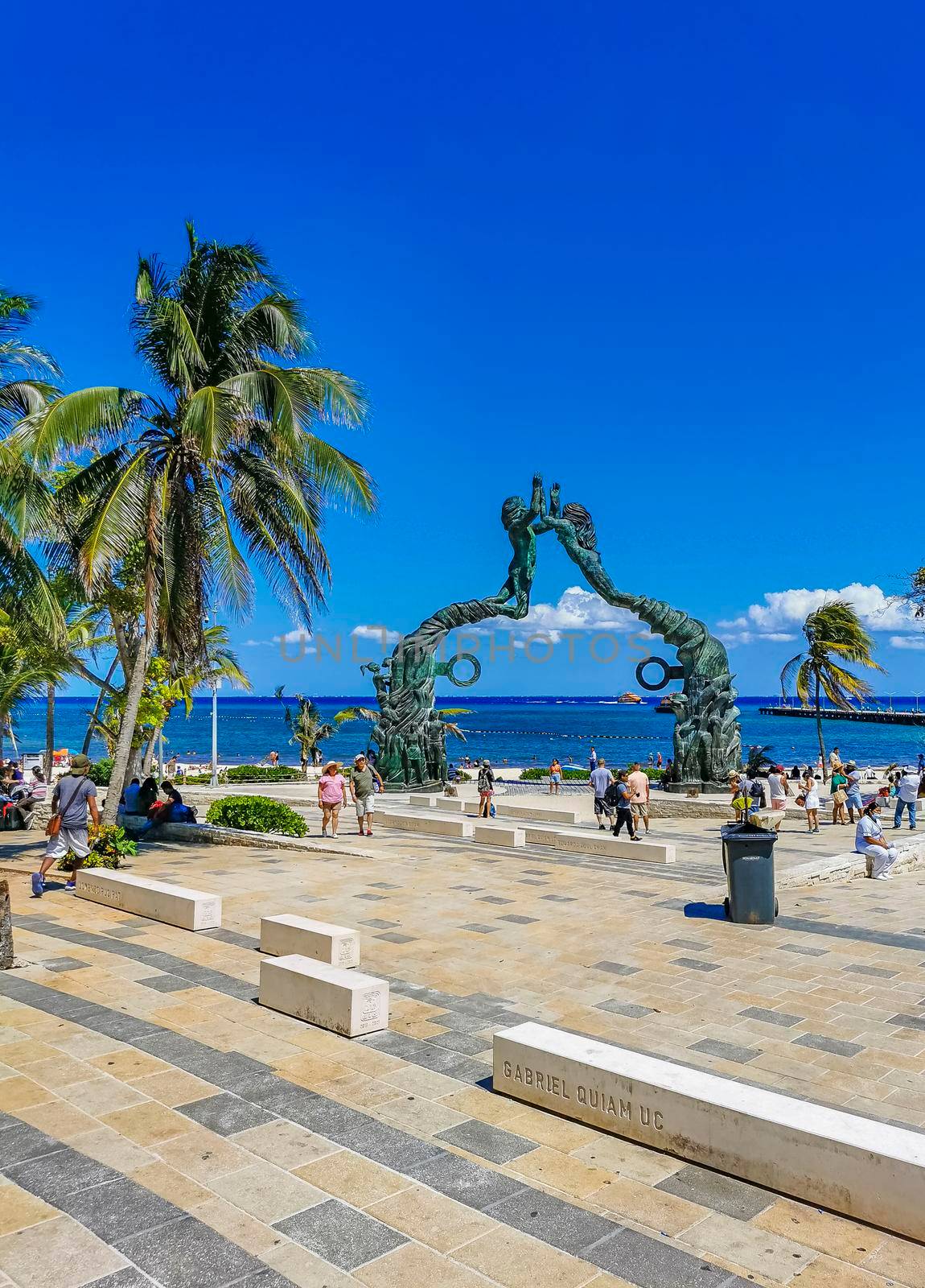 Playa del Carmen Mexico 14. May 2022 The ancient architecture of the Portal Maya in the Fundadores park with blue sky and turquoise seascape and beach panorama in Playa del Carmen Quintana Roo Mexico.