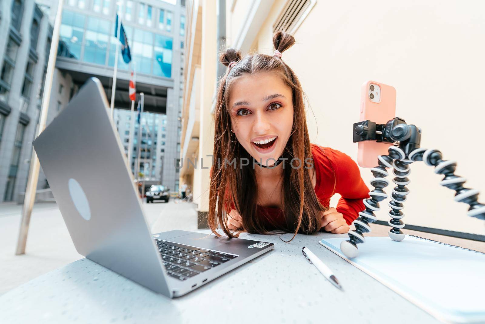 Young woman in a summer cafe doing remote work. Freelancer woman. Small business