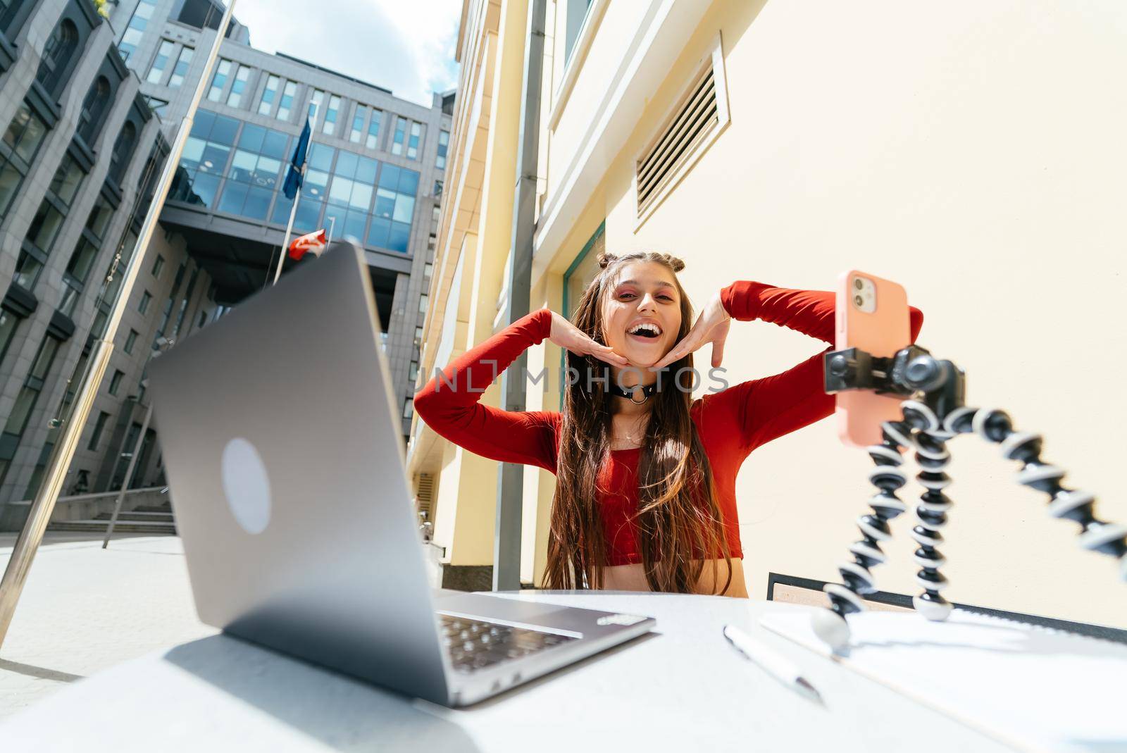 Young woman in a summer cafe doing remote work. Freelancer woman. Small business