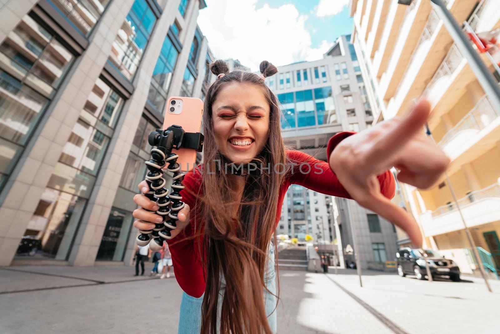 Young female blogger streaming on the street. Close view