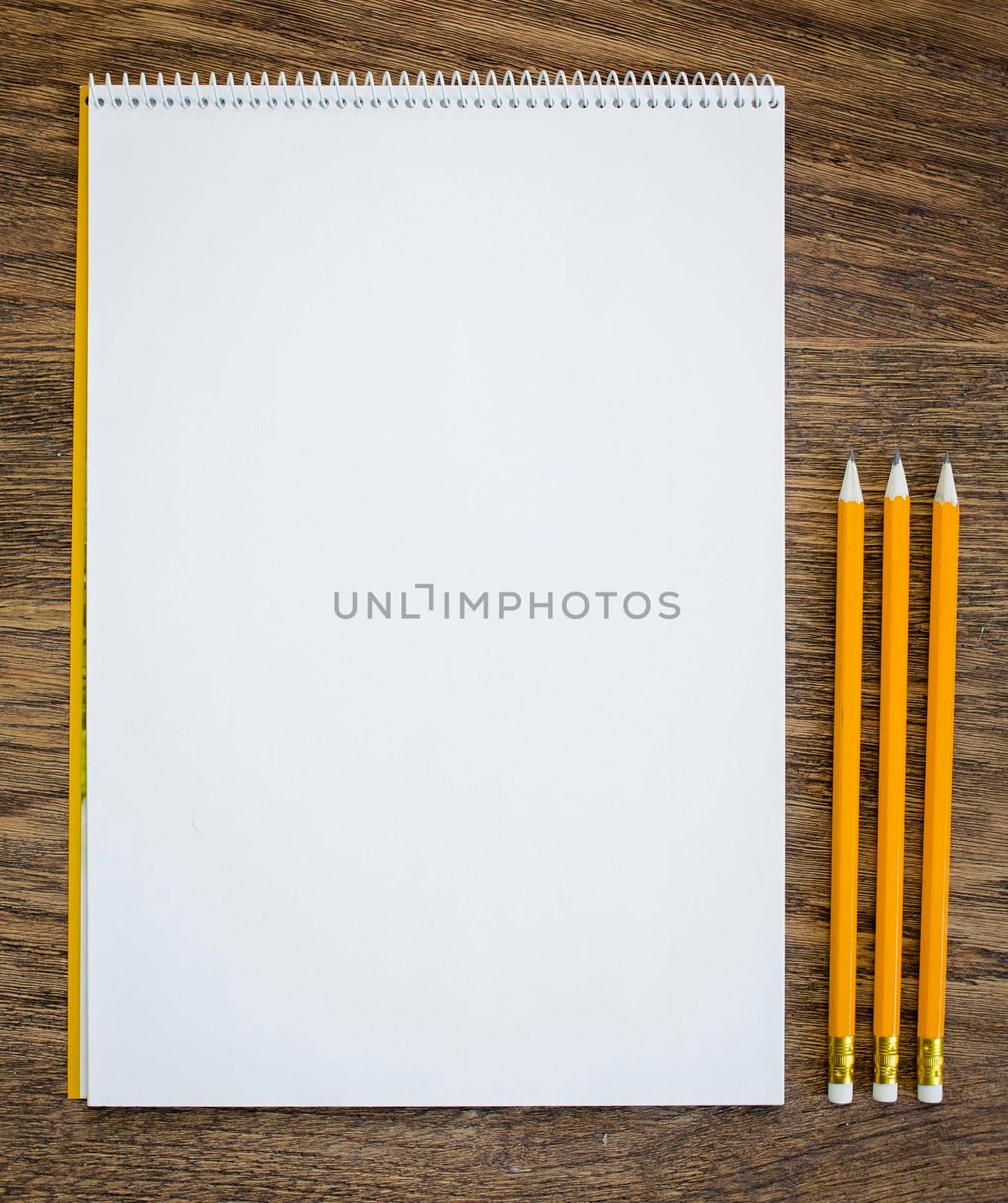 Paper and pencils on the wooden table. close-up.