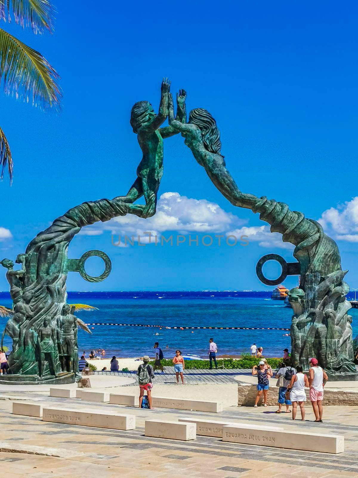 Playa del Carmen Mexico 14. May 2022 The ancient architecture of the Portal Maya in the Fundadores park with blue sky and turquoise seascape and beach panorama in Playa del Carmen Quintana Roo Mexico.