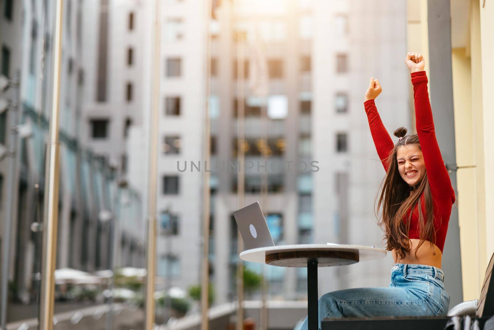 The girl speaks on a video link on the street. Meeting on the street. Modern types of work. Work remotely