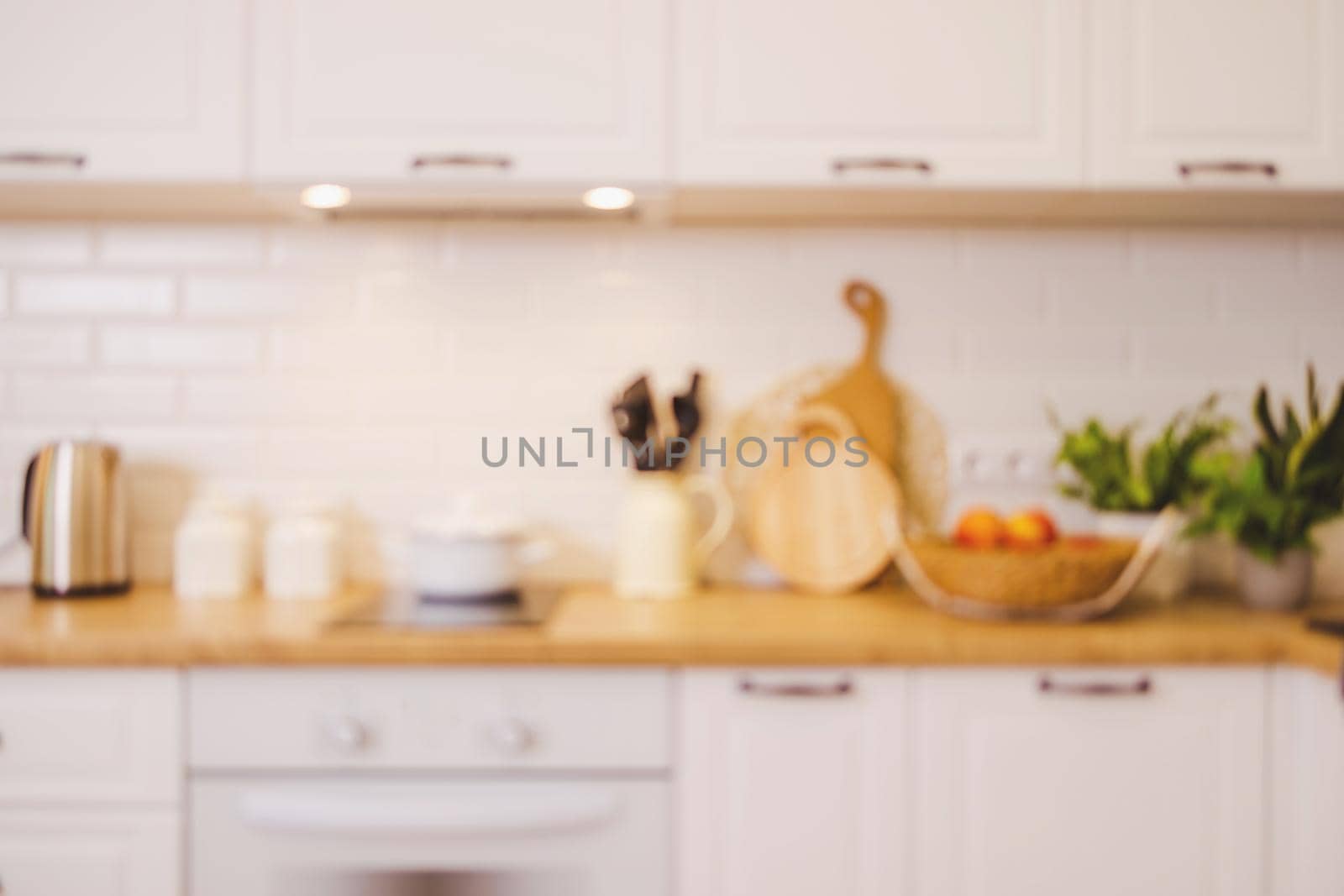 Against the background of a blurred interior of a white kitchen, Mockup by Ramanouskaya