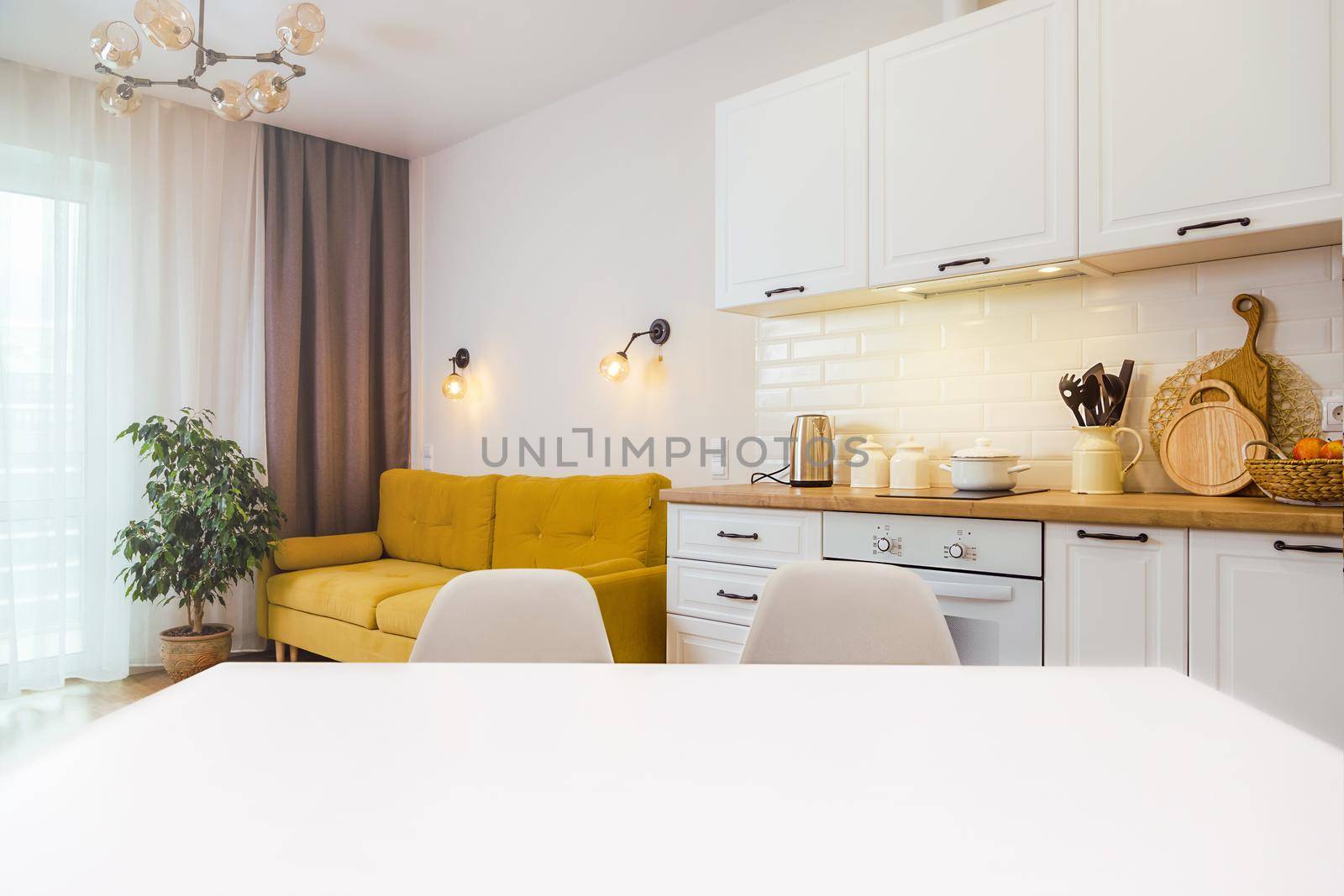 Mockup, empty table in bright kitchen interior. Copy paste for your design by Ramanouskaya