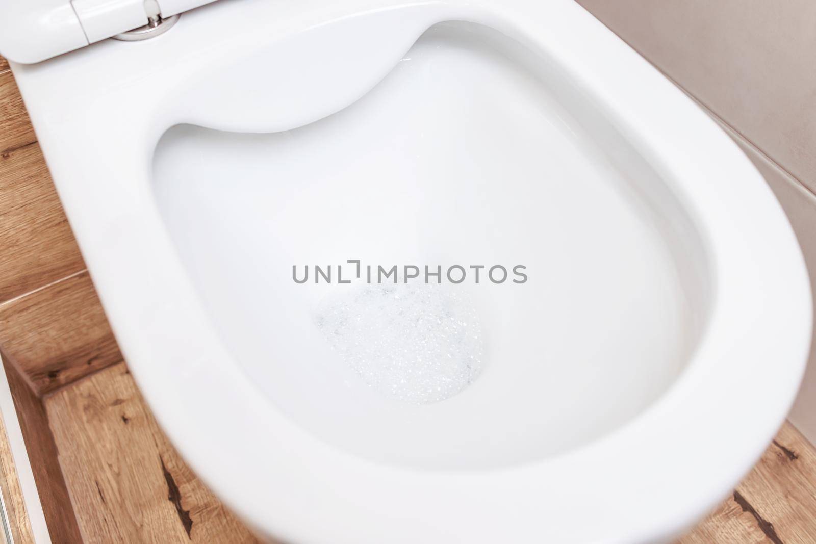 clean, white, new toilet close-up in the bathroom by Ramanouskaya