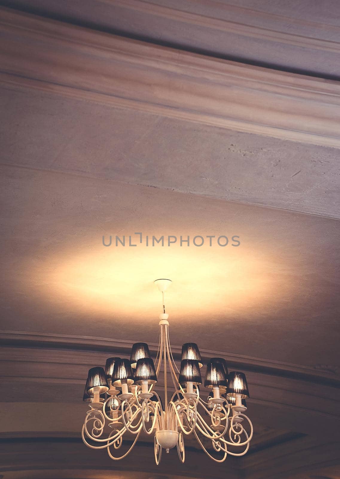 chandelier shines on the ceiling