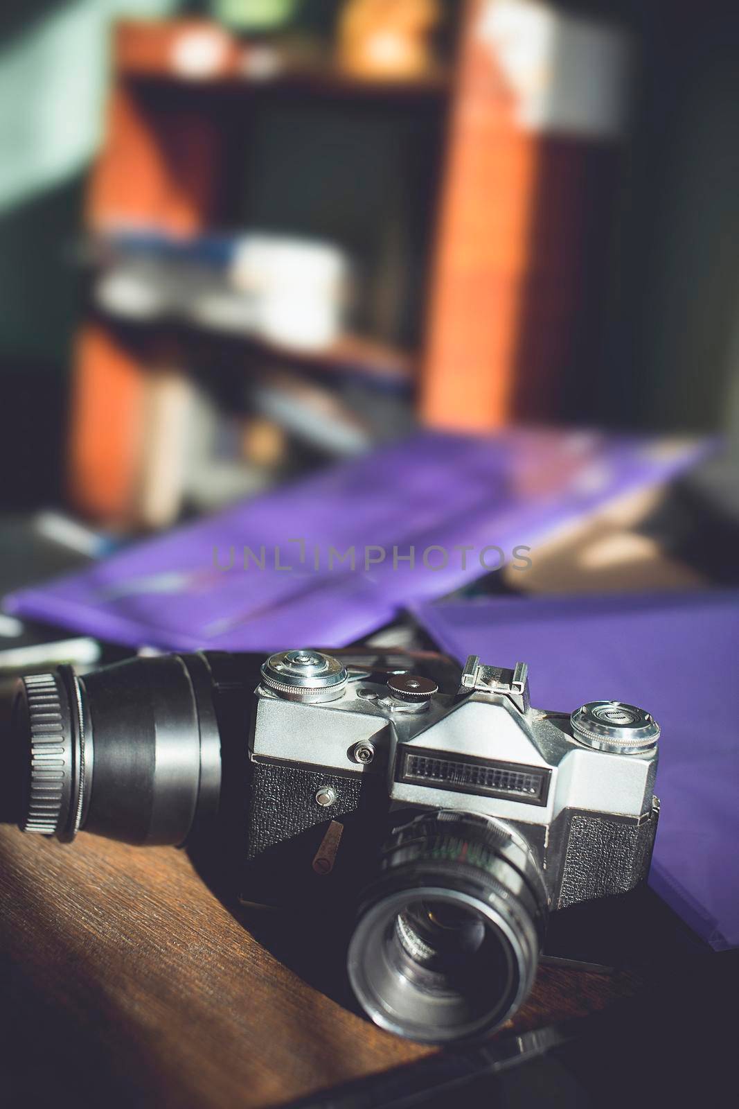 Retro photo camera on a wooden table. vintage style.