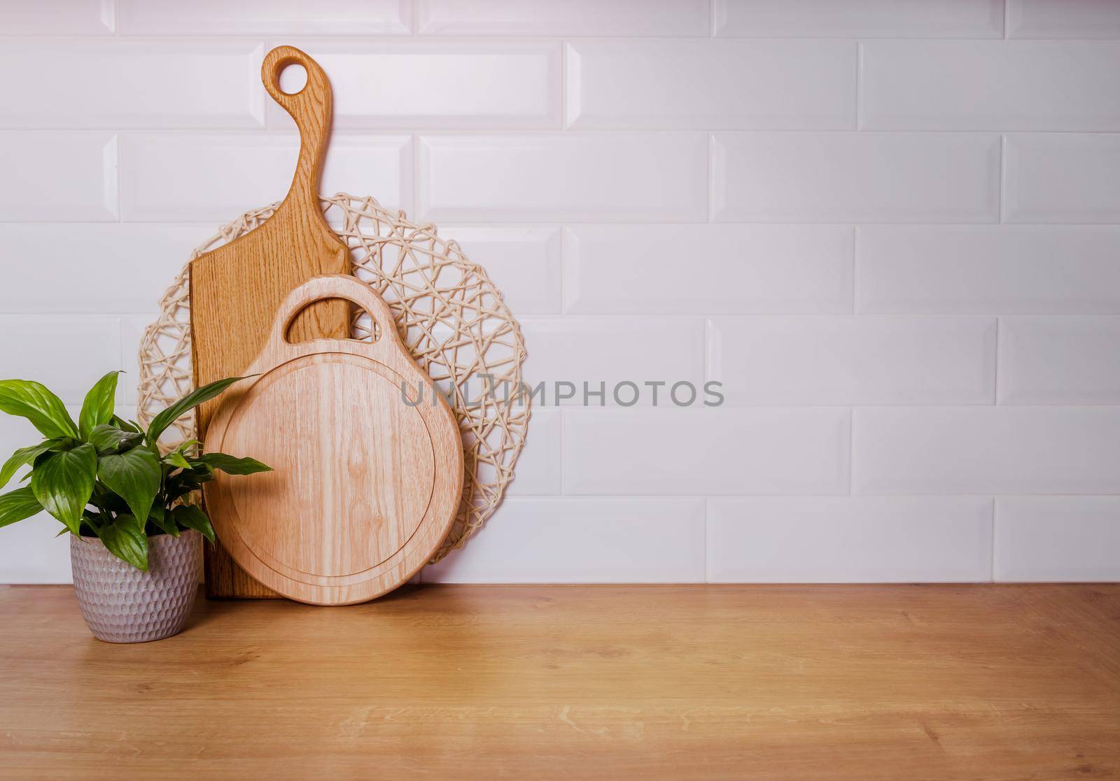 Beautiful boards for cutting meat on a white wall background, mockup by Ramanouskaya