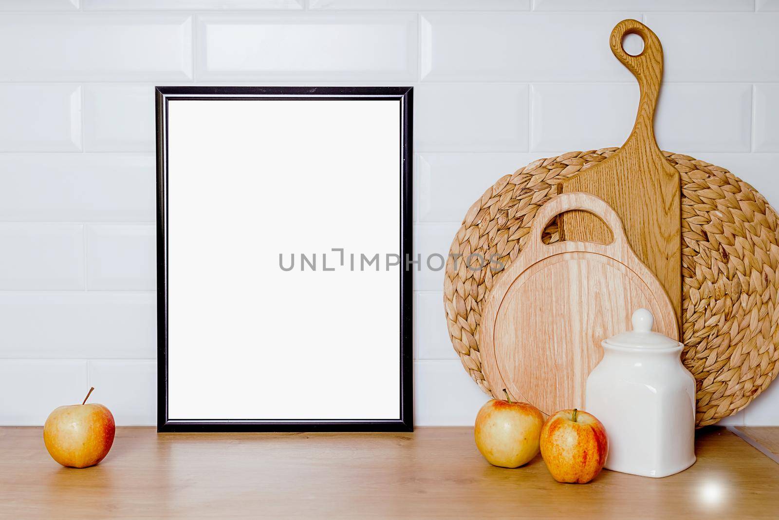 mockup in vintage style with black frame, kitchen utensils on wooden table by Ramanouskaya