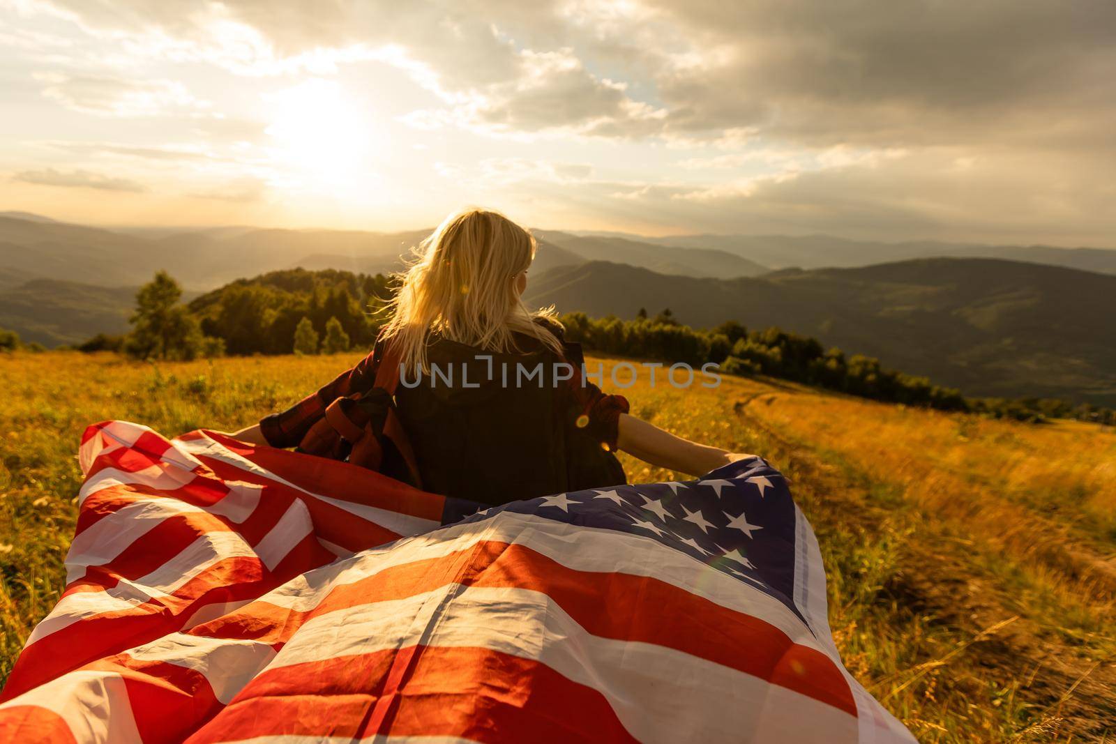 young beautiful woman holding USA flag