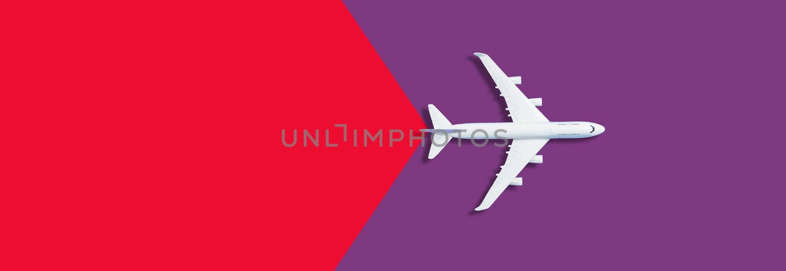 Flat lay design of travel concept with plane on red background with copy space by Andelov13