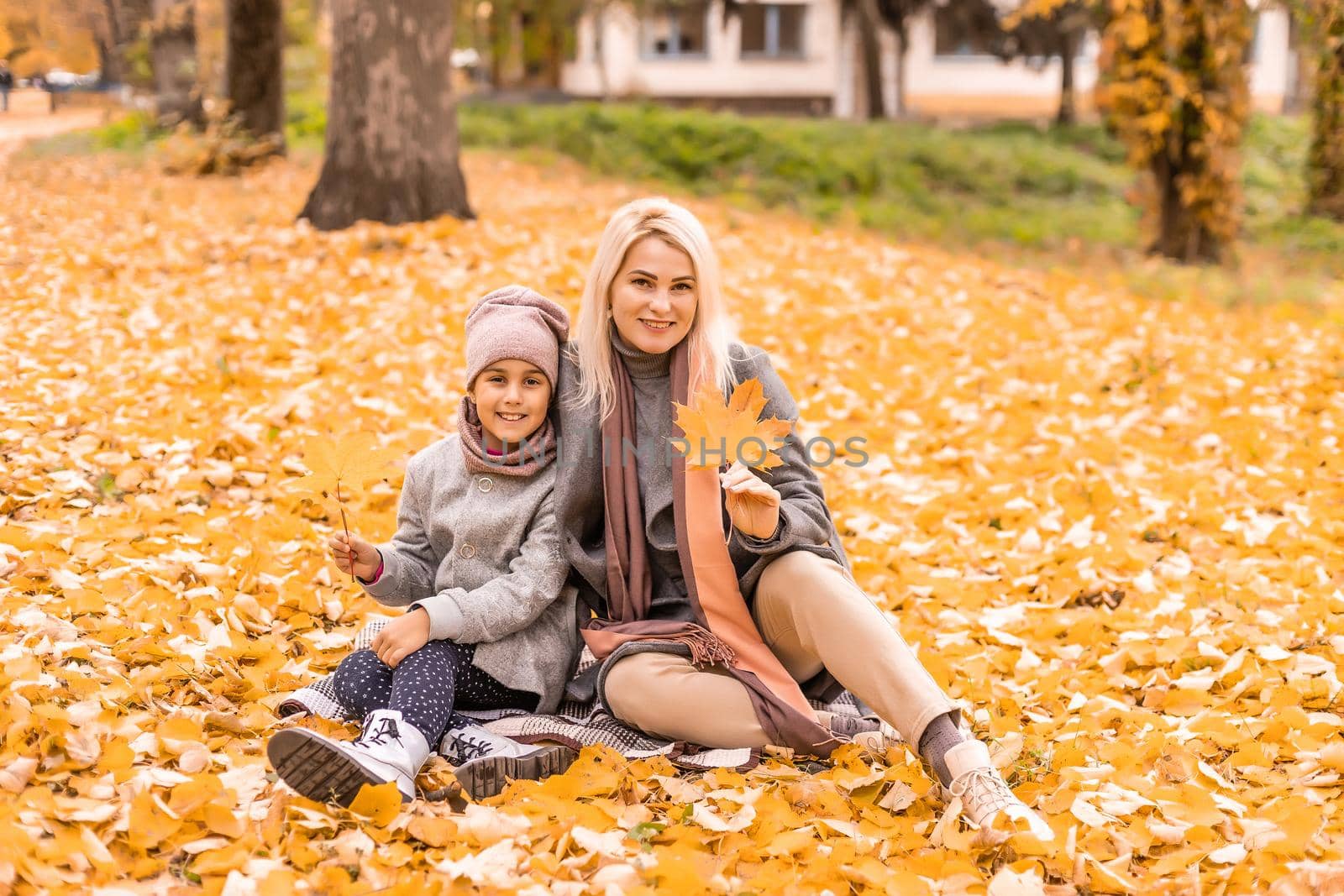 Mother and daughter in autumn yellow park