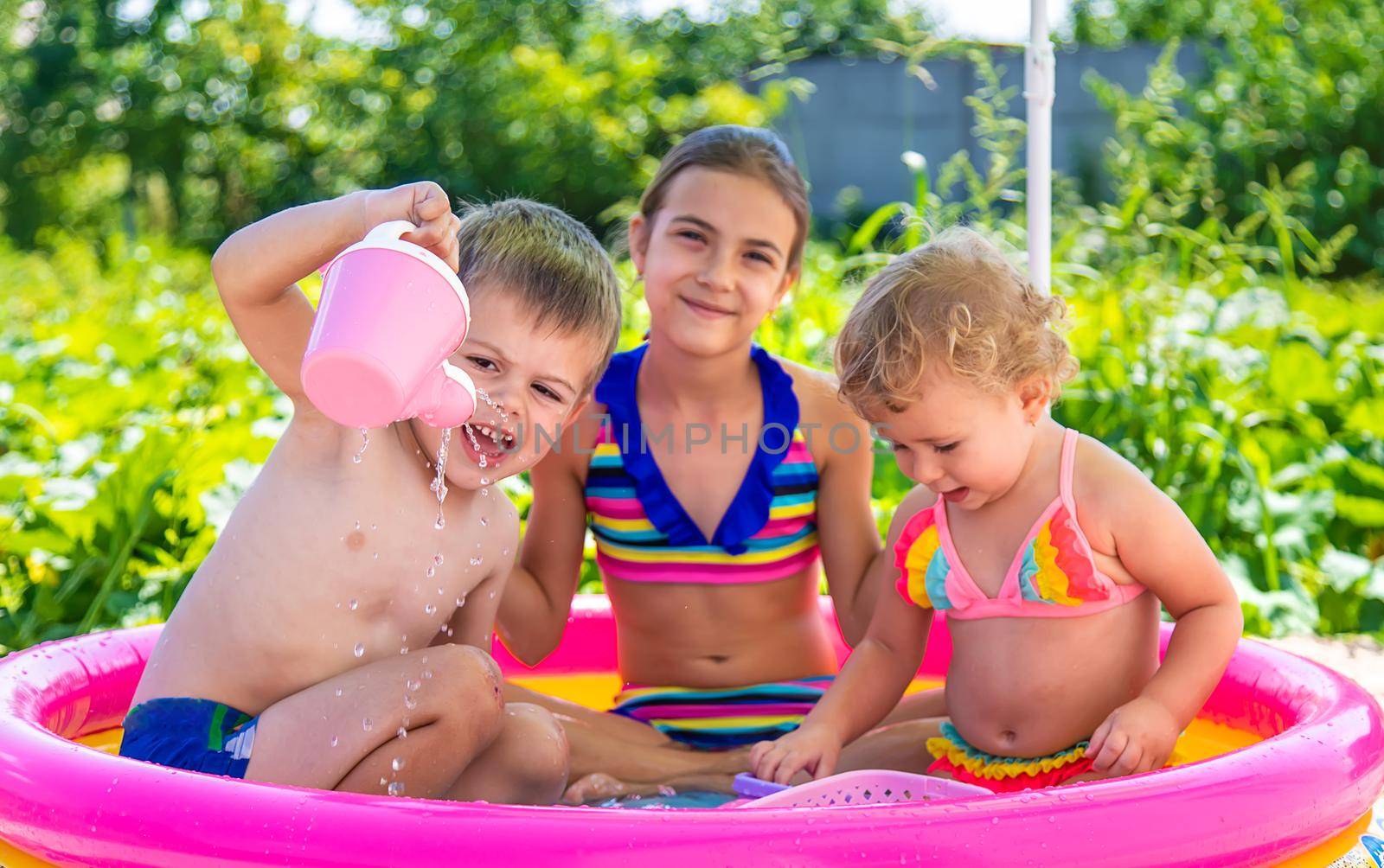 Children swim in the pool. Selective focus. by yanadjana