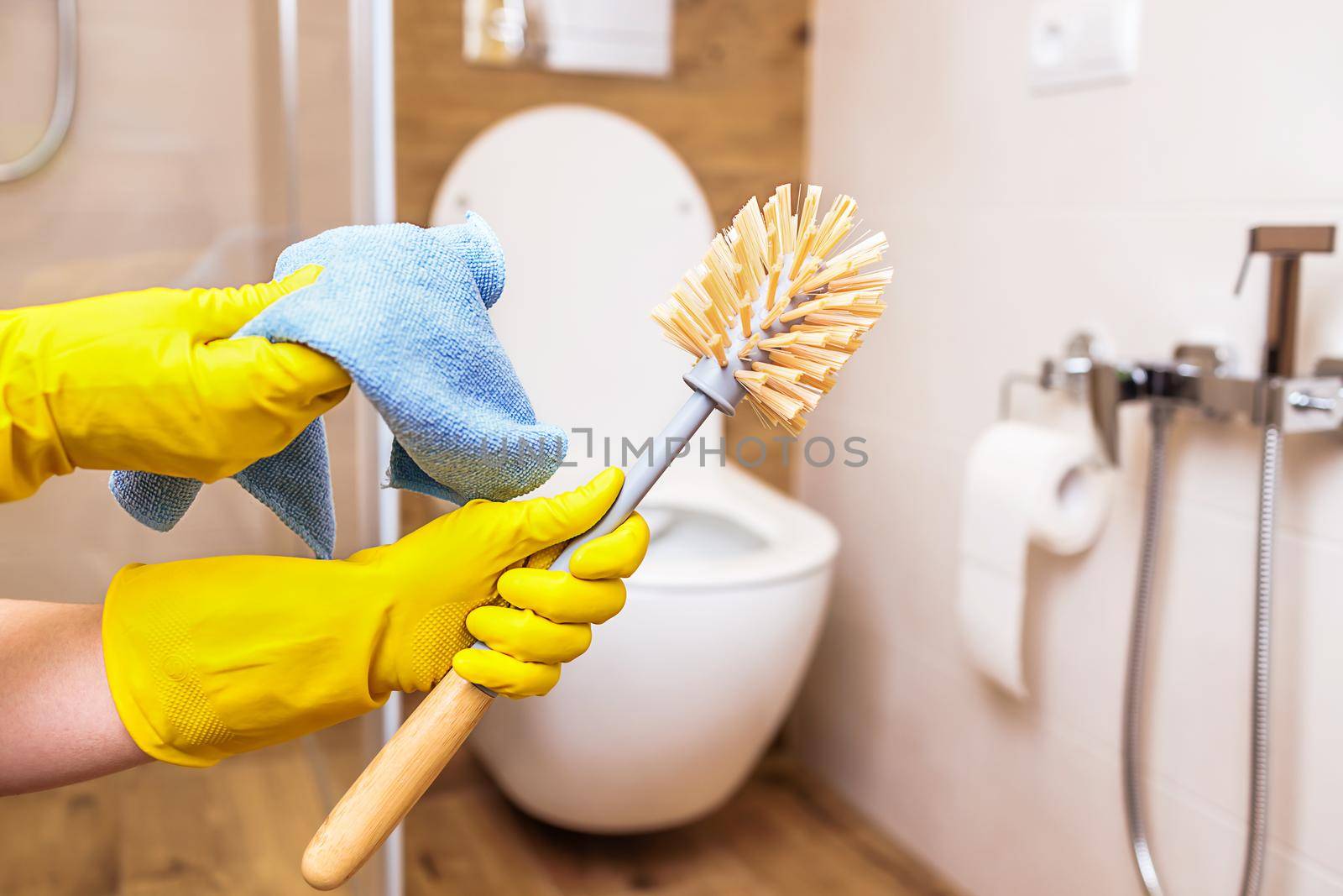 close-up, hands in gloves with equipment for hygienic cleaning of the bathroom by Ramanouskaya