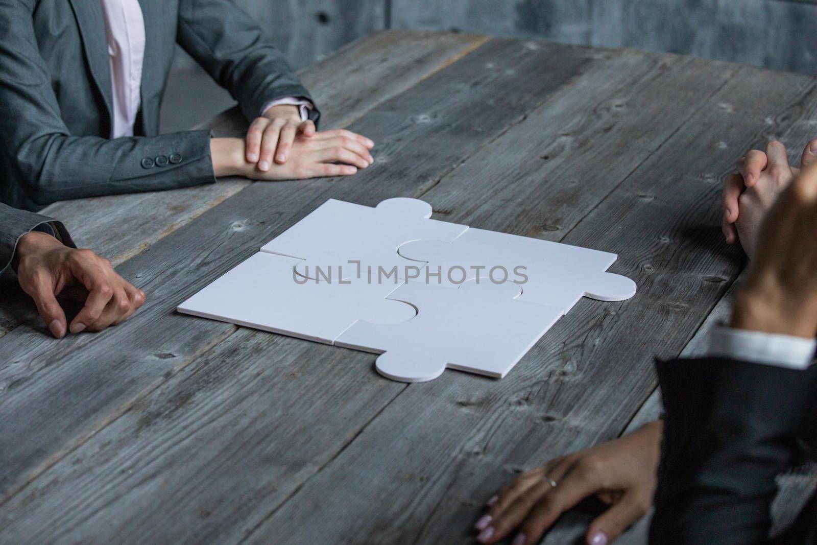 Business teamwork with merged white puzzle cooperation unity , result of work concept