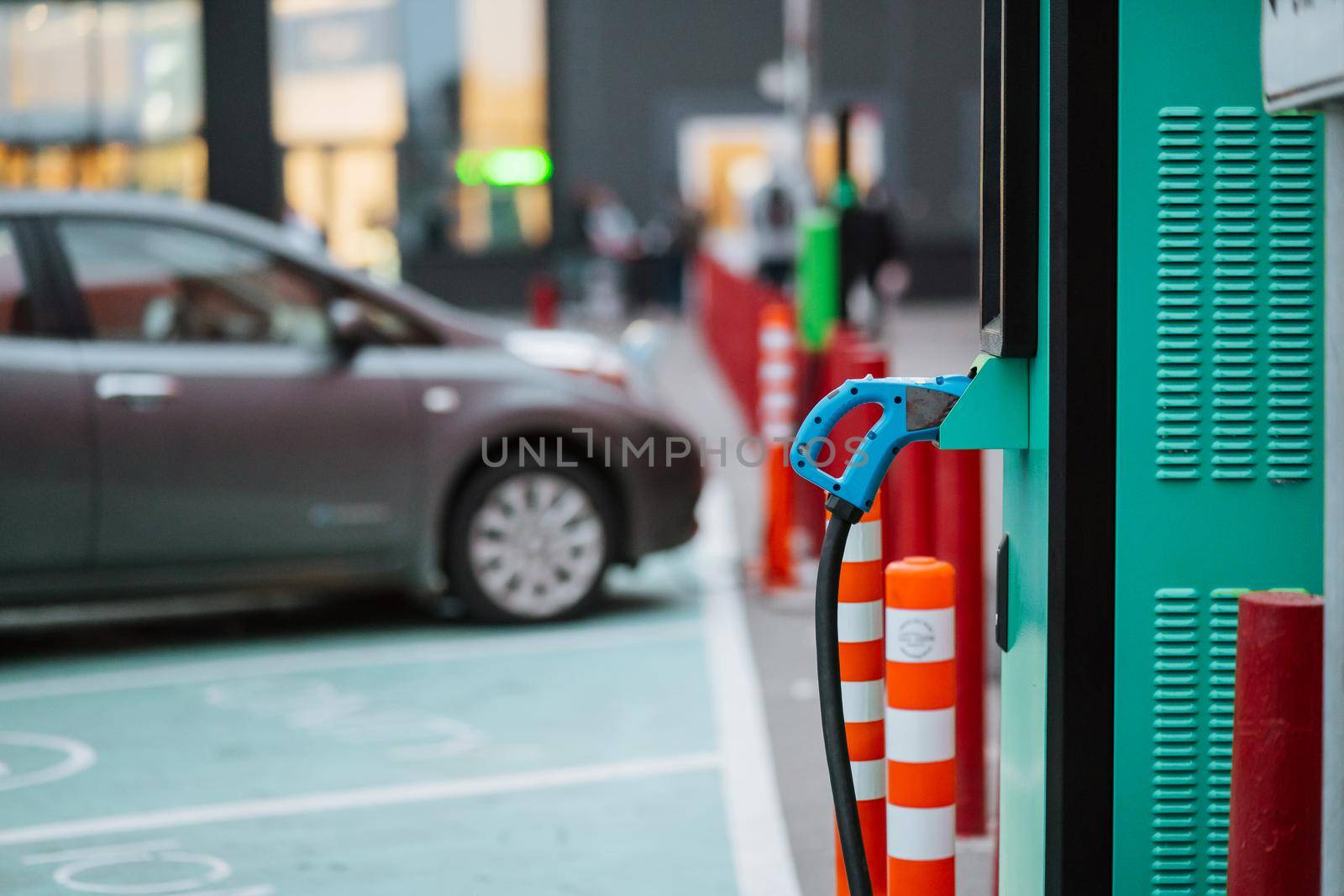 Close up power cord for electric car. Green station