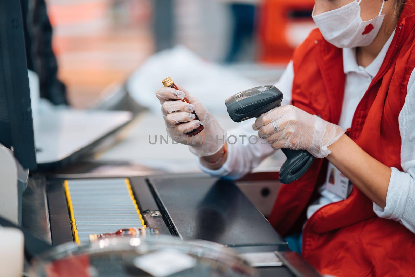 A woman reads the bar code at checkout machine