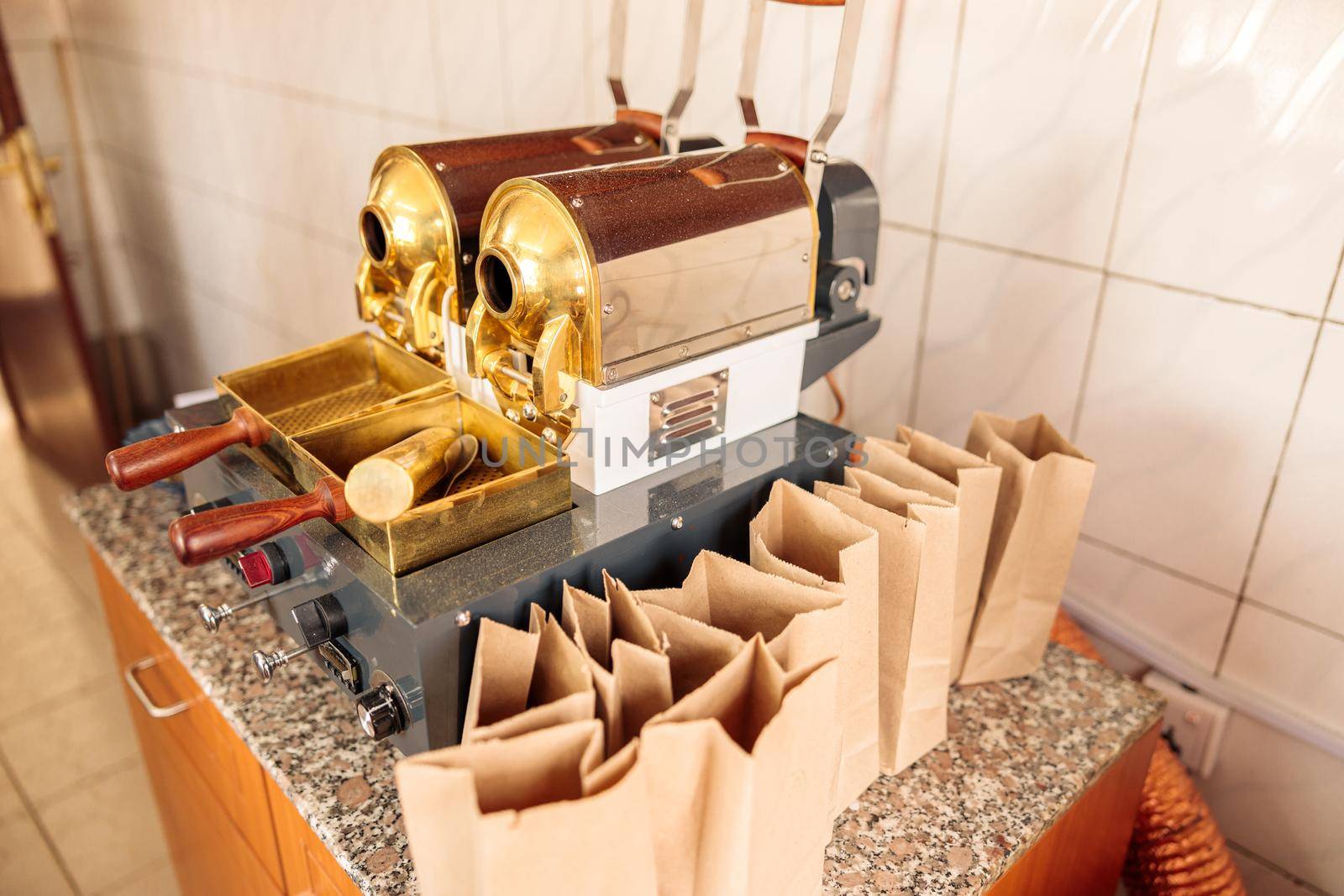 Top view of coffee bean grinder and paper bags at the factory