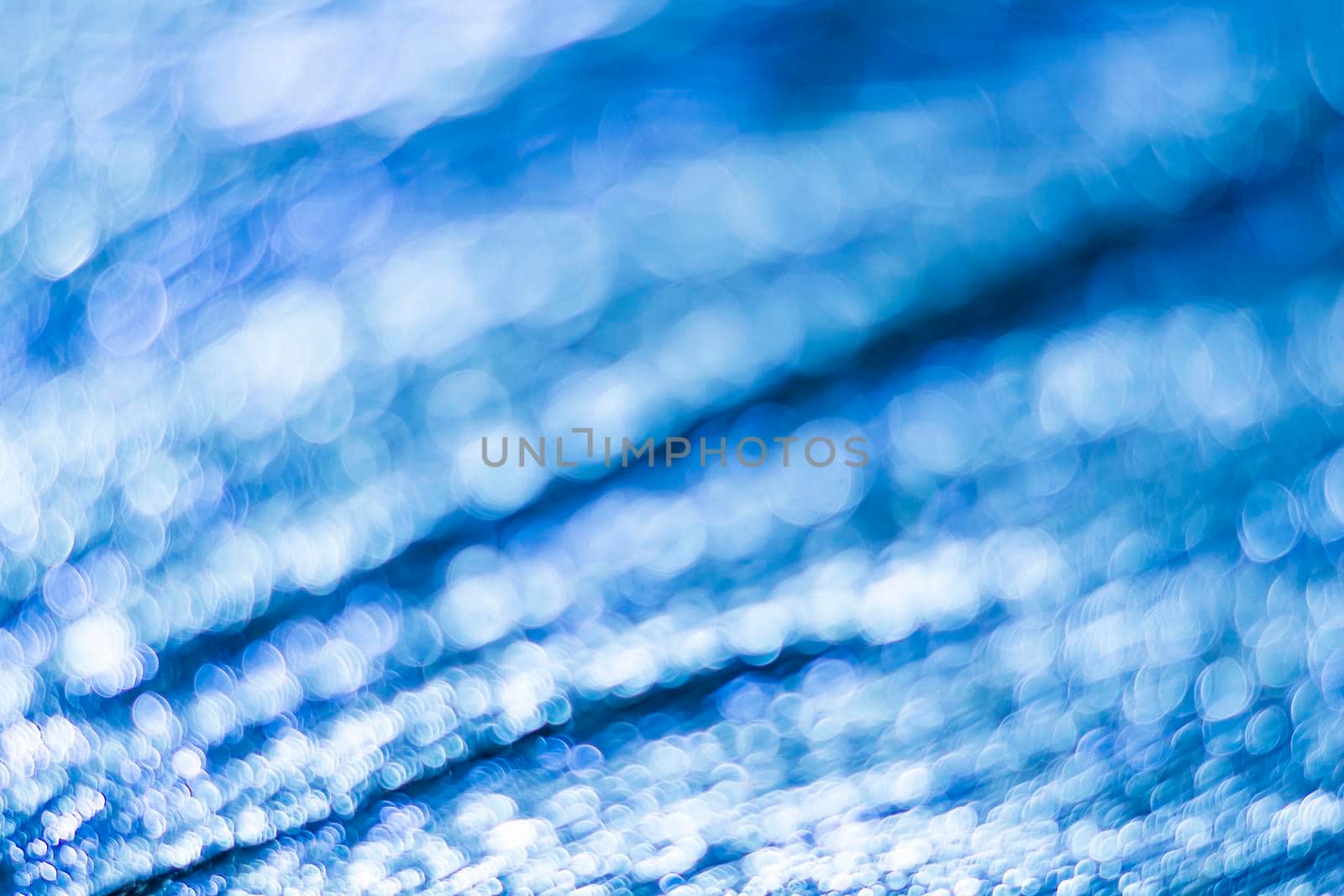 Blue bokeh. Abstract background. Defocused lights.