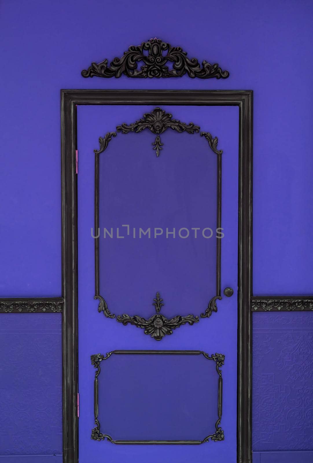 Old dramatic violet doors on the background of the wall.