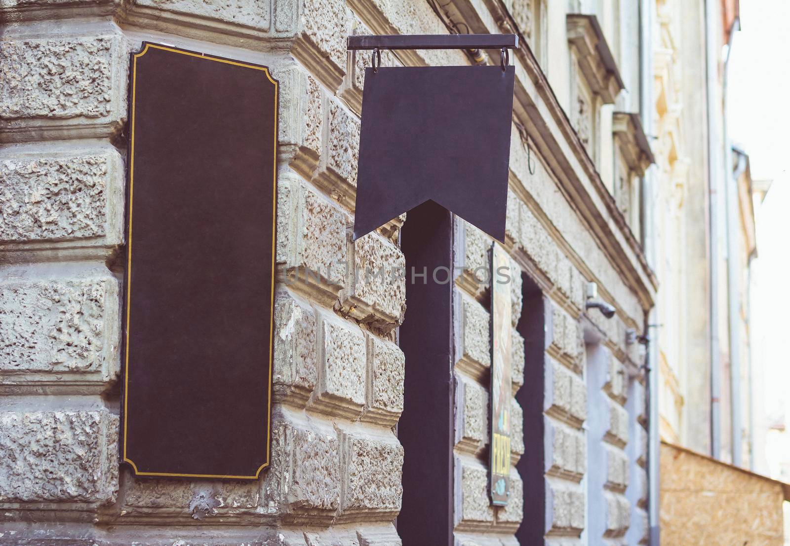 An old retro signboard on the wall of the old city.