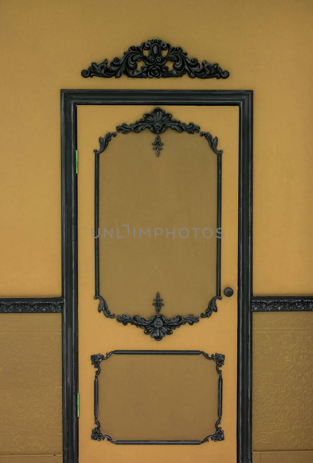 Old dramatic brown doors on the background of the wall.