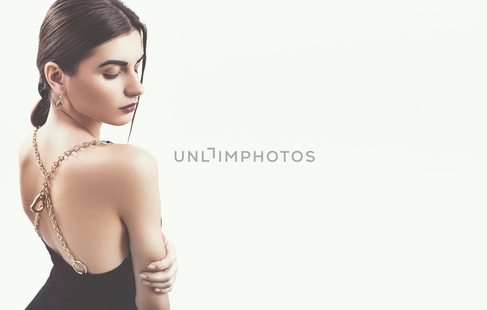 Portrait of nice young gorgeous woman on gray solid backgrounds. To a lots of copy space.