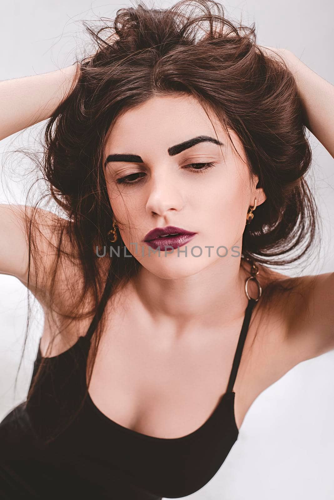 Portrait of nice young gorgeous woman on gray solid backgrounds.