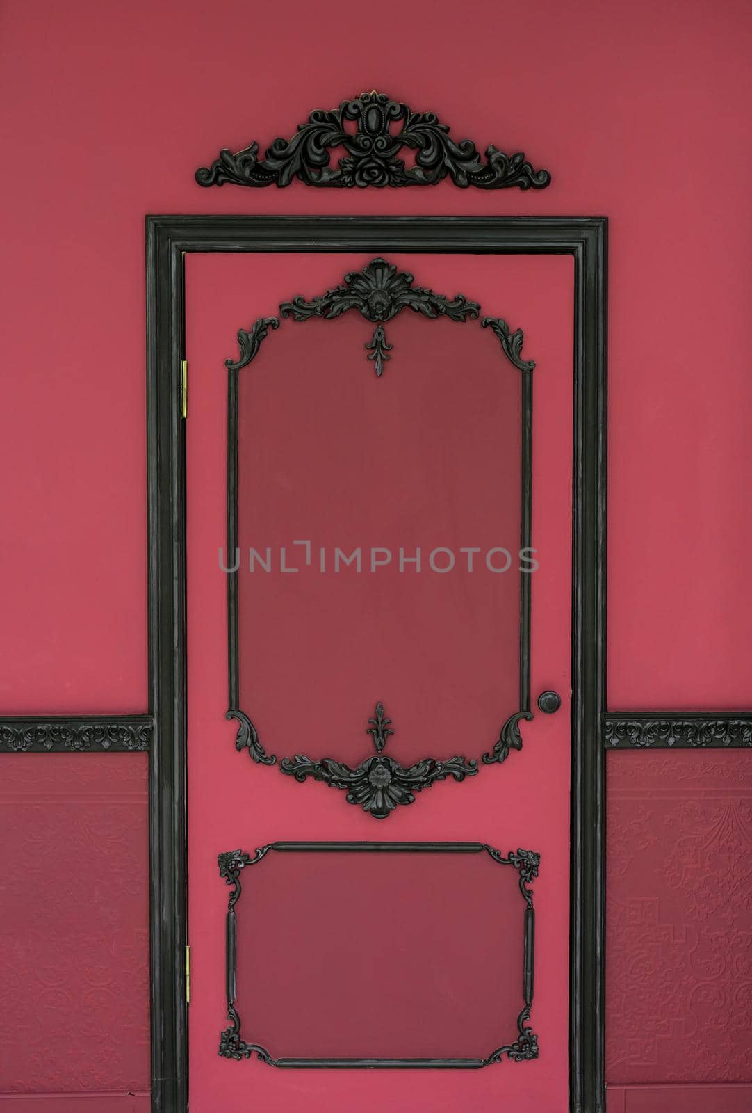 Old dramatic red doors on the background of the wall.