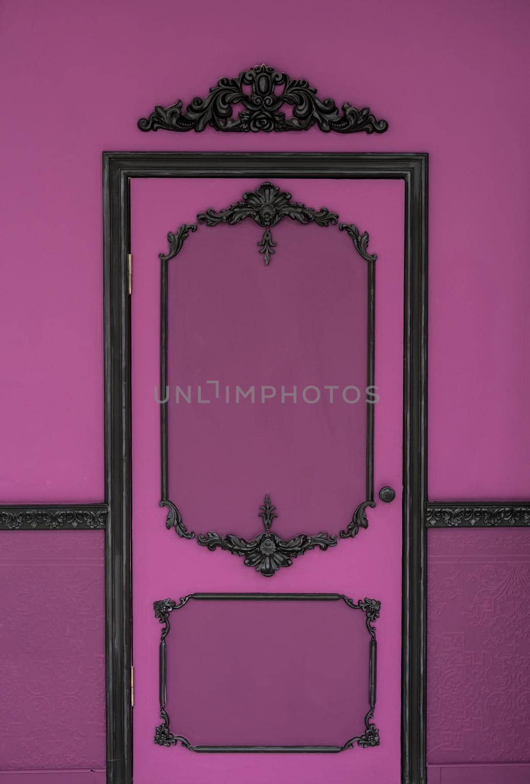 Old dramatic pink doors on the background of the wall.