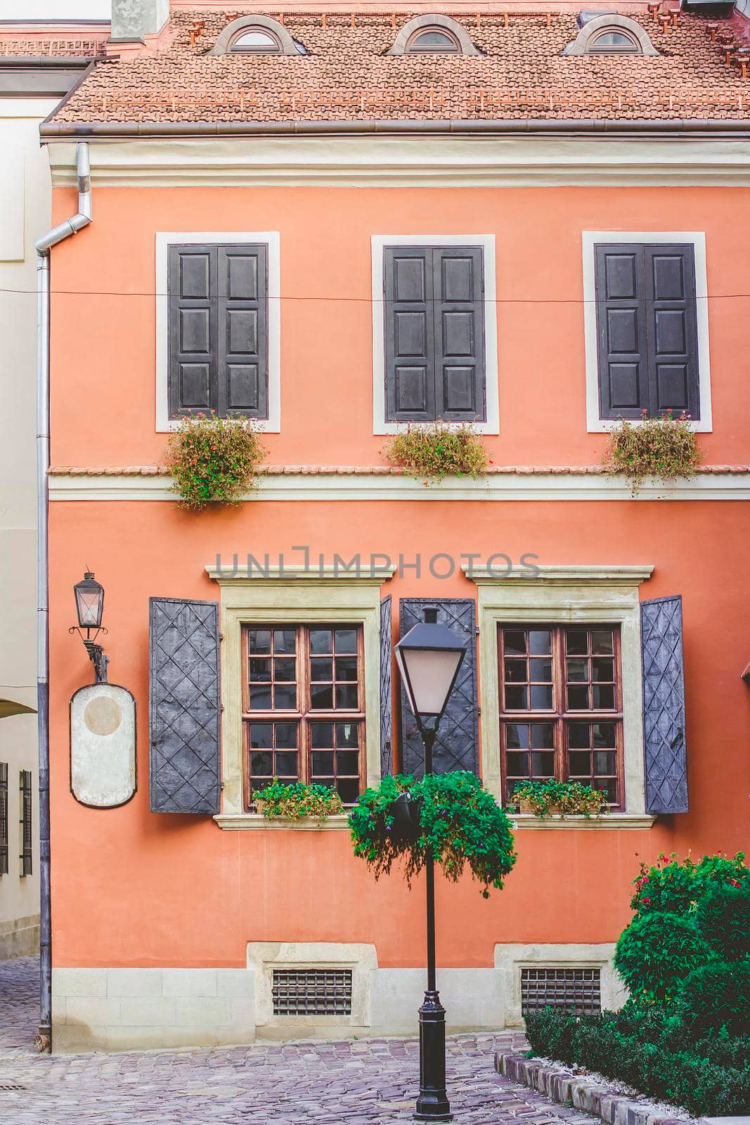 Old windows on the background of an orange wall in the old courtyard of the city.