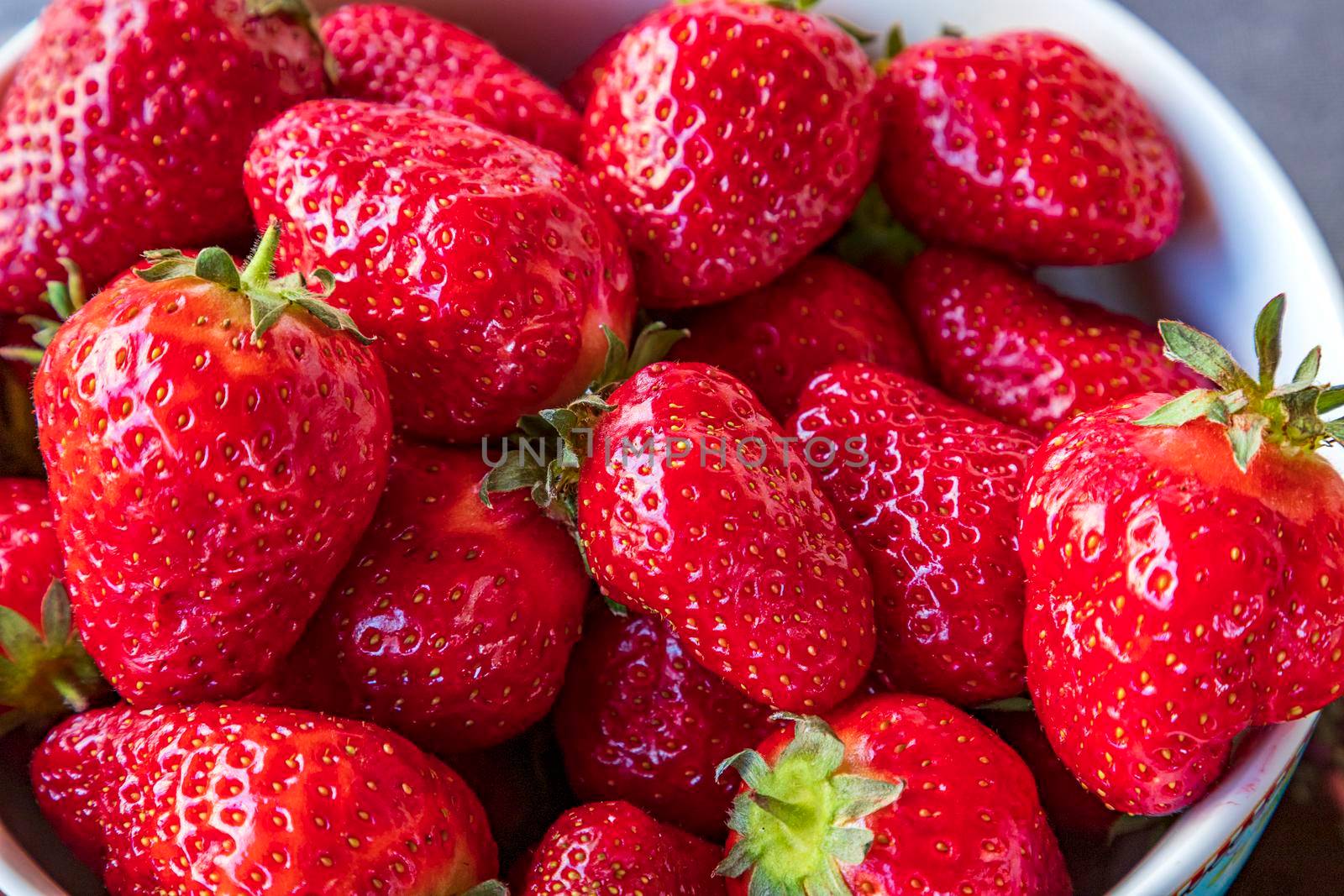 Freshly picked strawberry on a plate. Close up