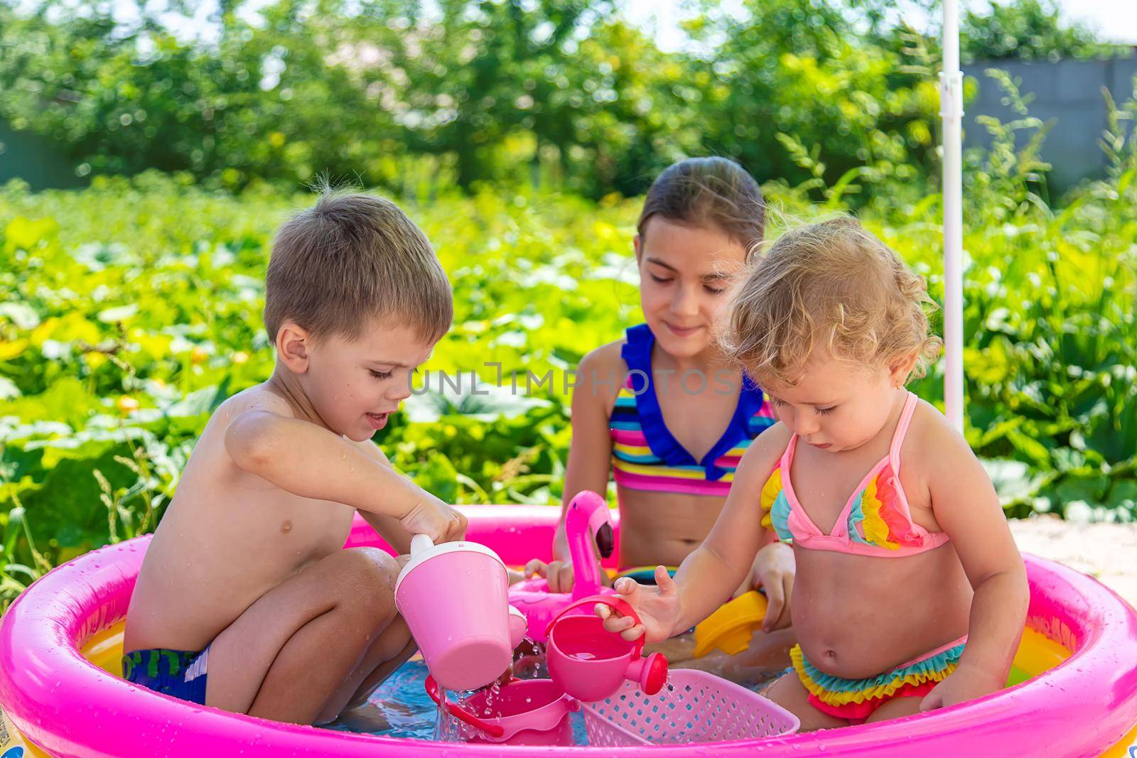 Children swim in the pool. Selective focus. Kid.