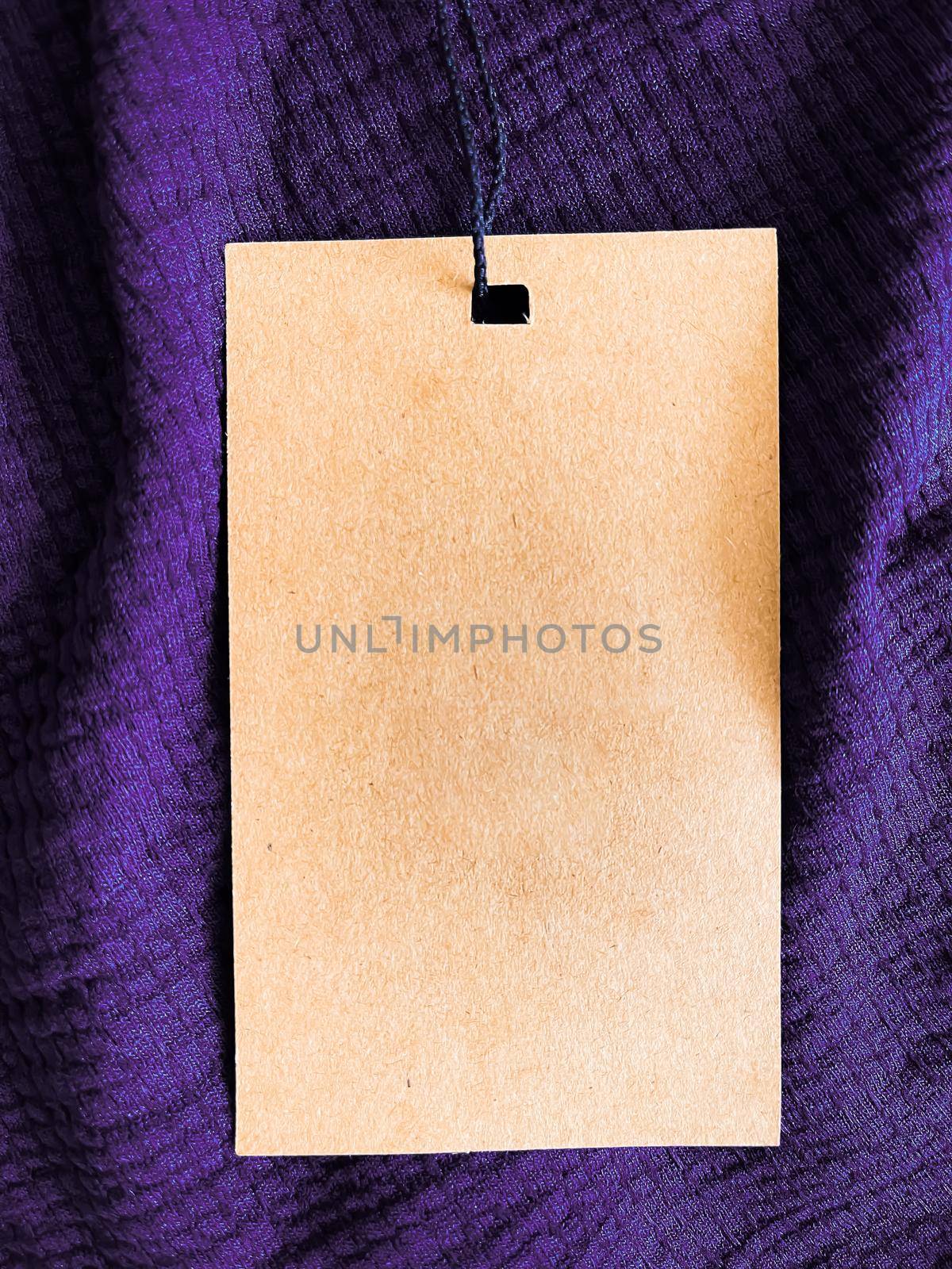 Blank fashion label tag, sale price card on luxury fabric background, shopping and retail concept