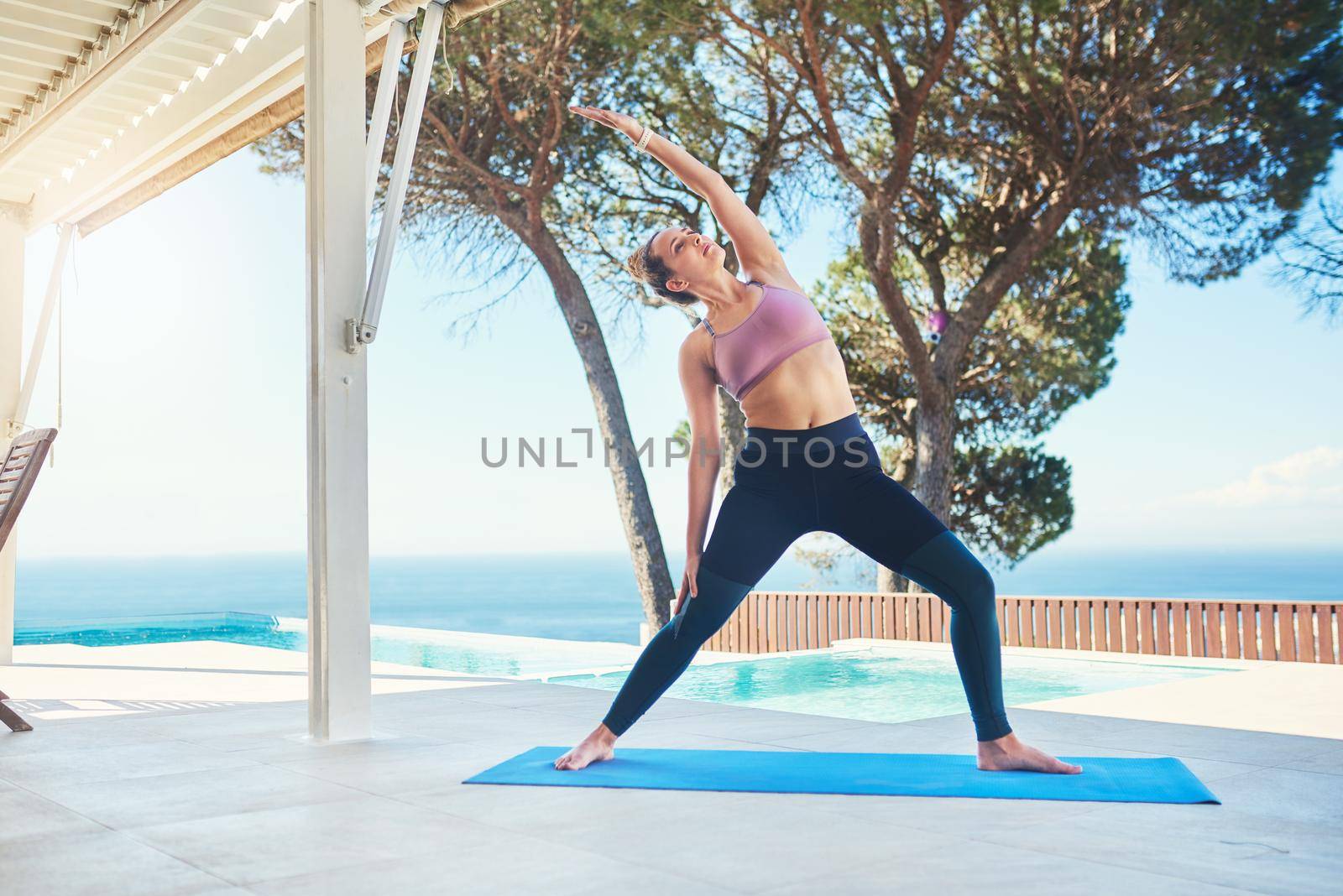 Yoga is how you get through life. a young female athlete practising yoga at home