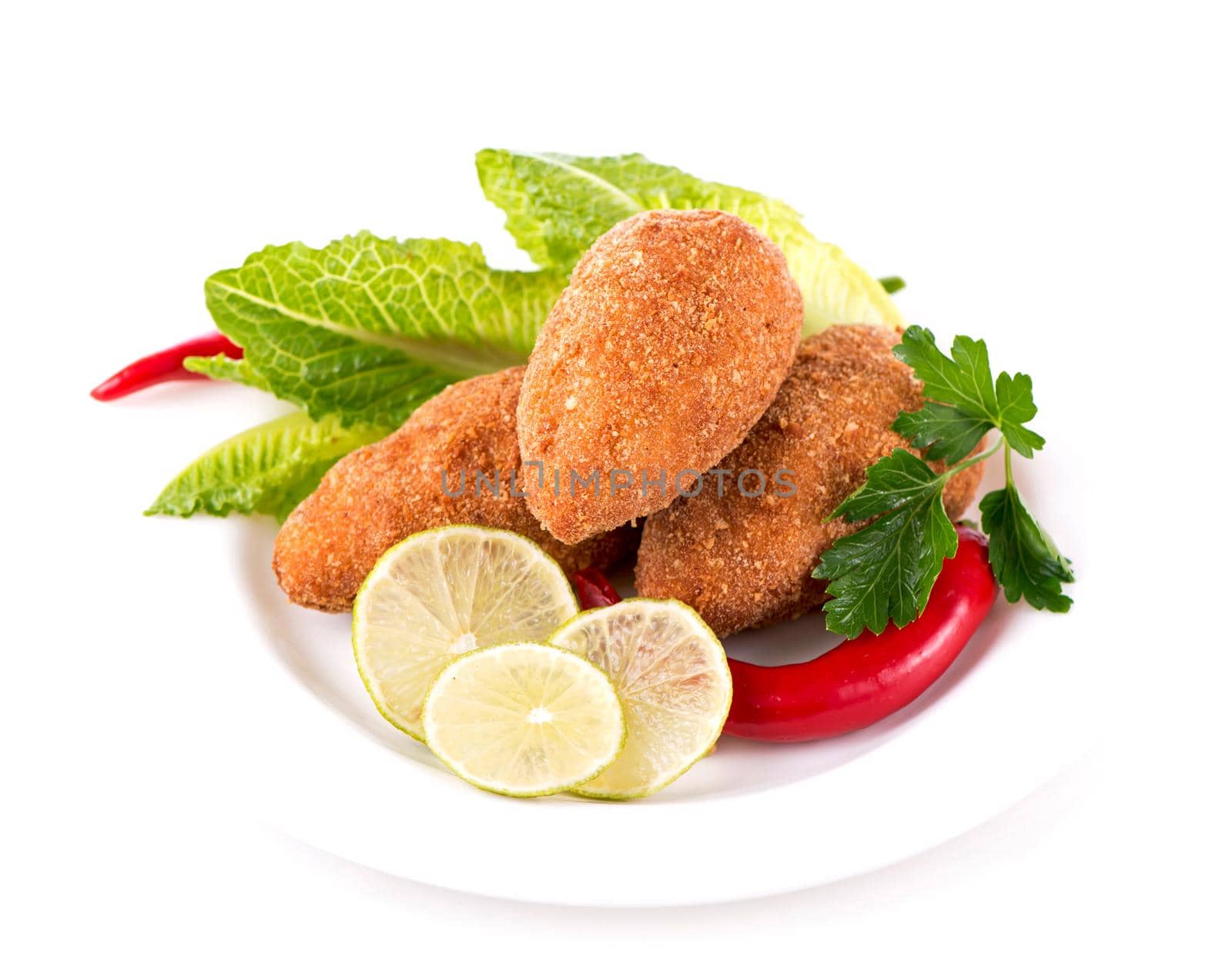 two fried breaded cutlet with vegetables and herbs on a plate isolated on white background by aprilphoto