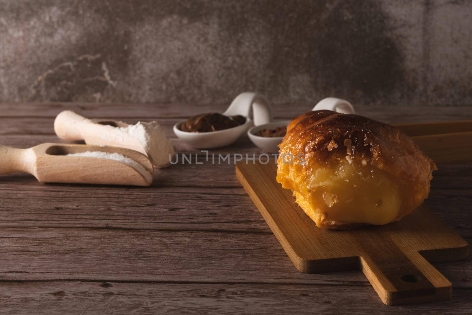 cream-filled puff pastry horn on a wooden board