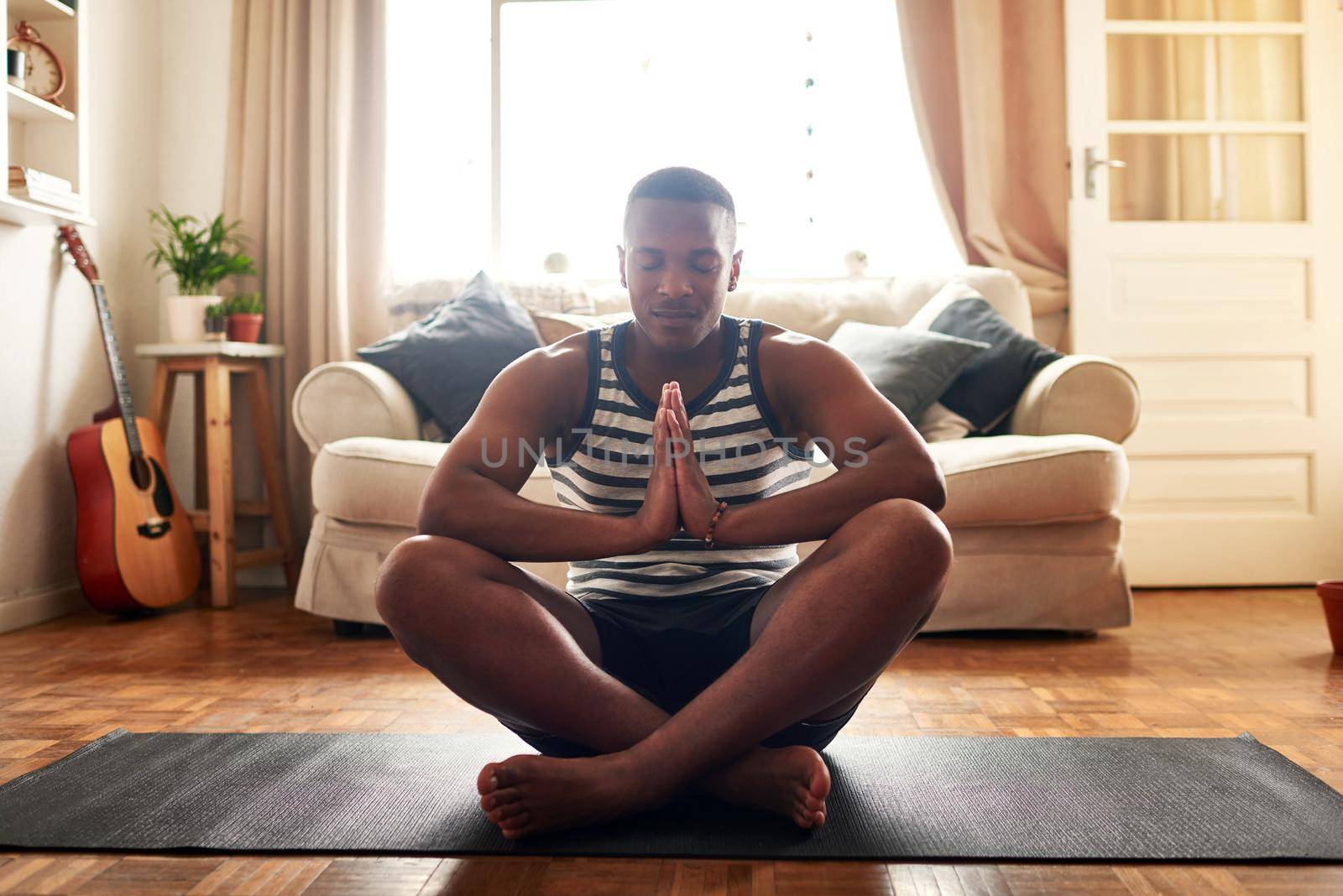Yoga made me a better person. a young man practising yoga at home during the day
