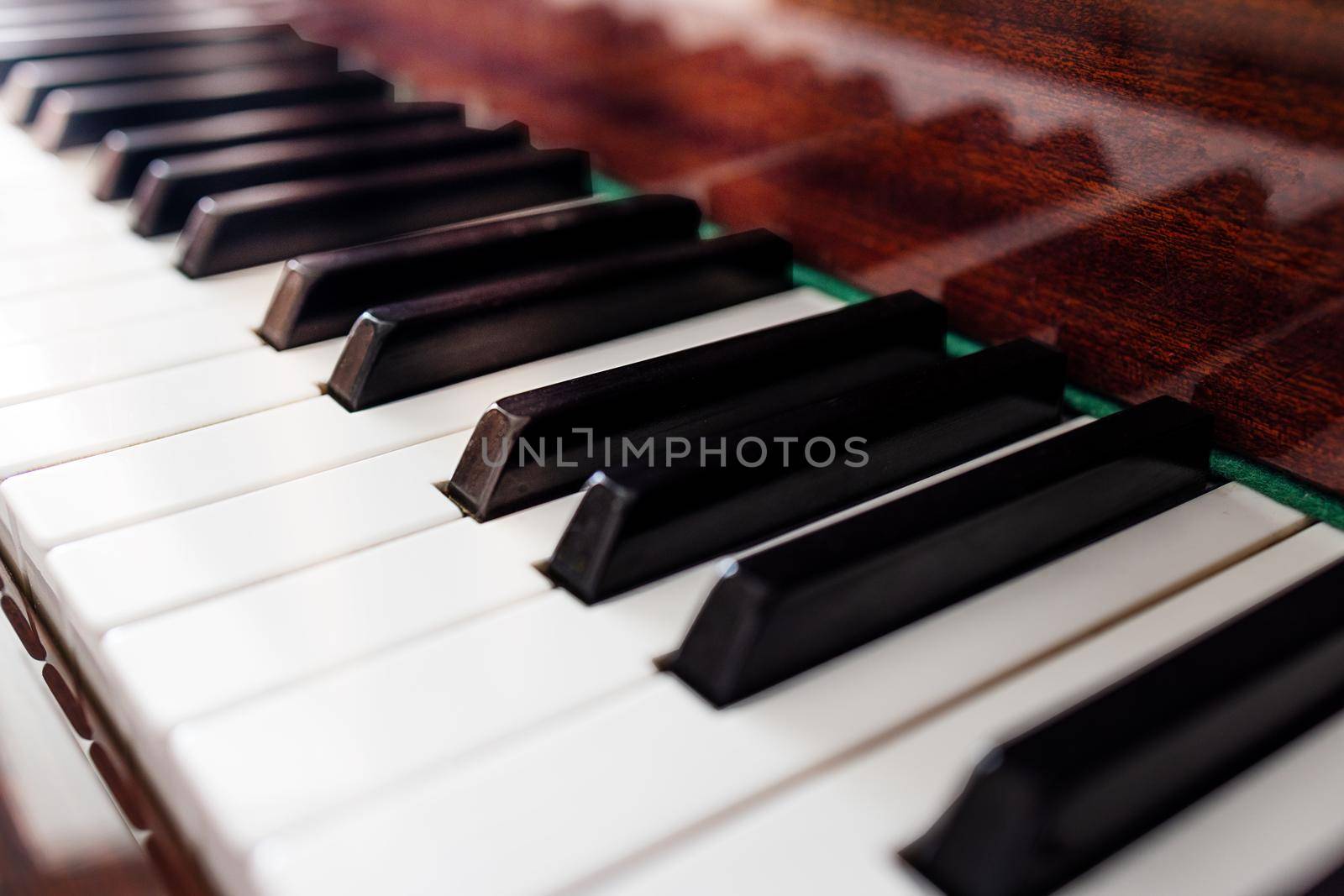 close-up, brown piano keys in the sun. Shallow depth of field. background for music banner or cover