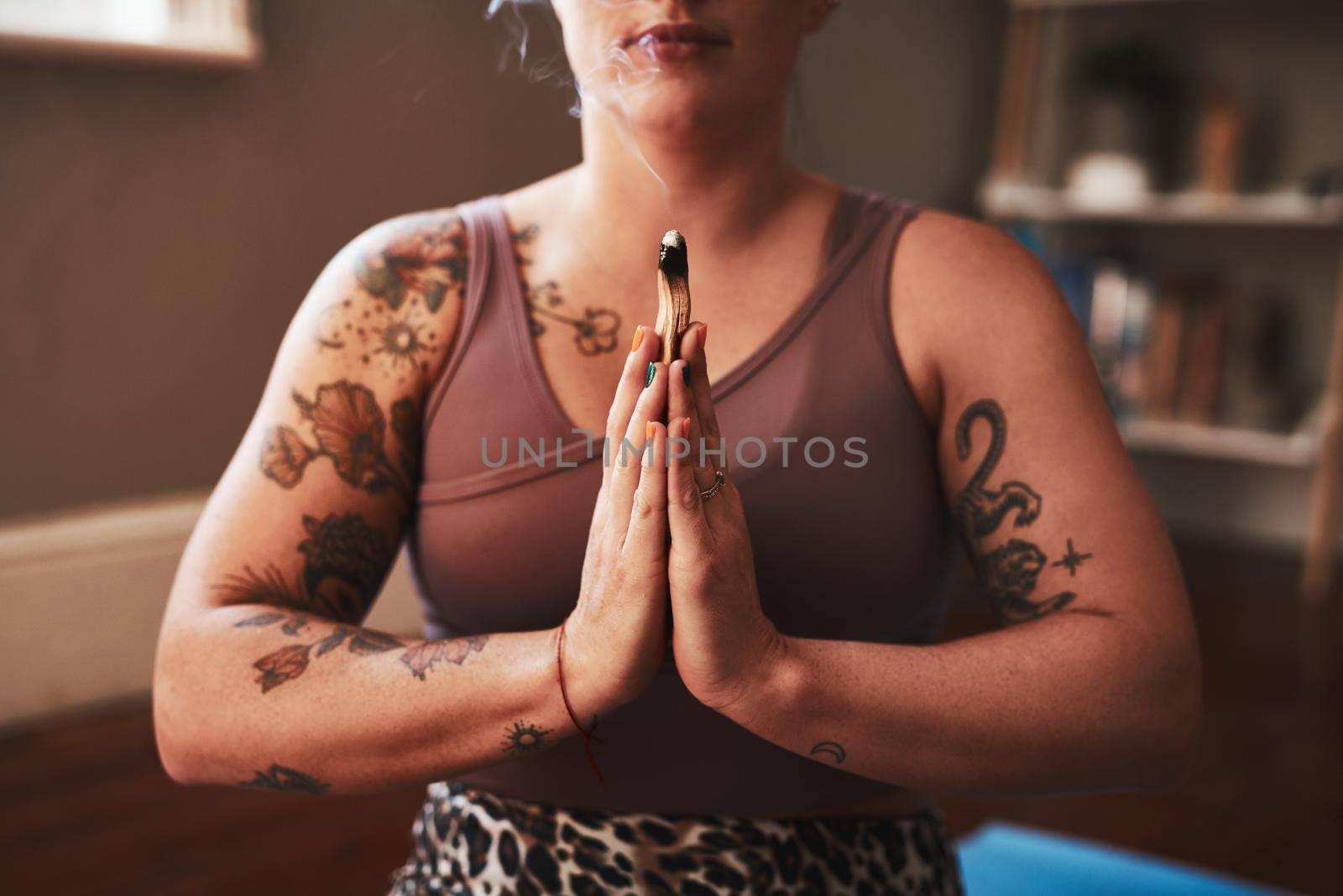 Connect to a deeper sense of purpose in your life. Closeup shot of a woman meditating at home. by YuriArcurs