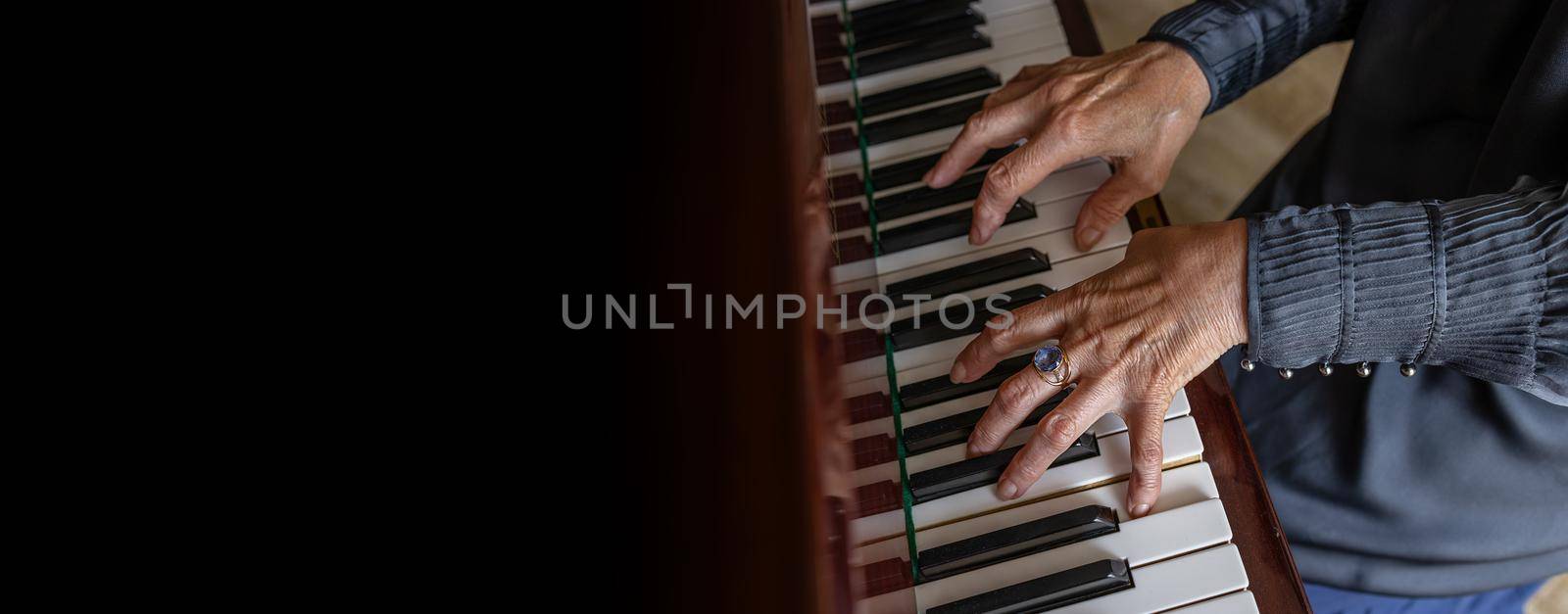 long banner, black background. close-up play the piano by Ramanouskaya