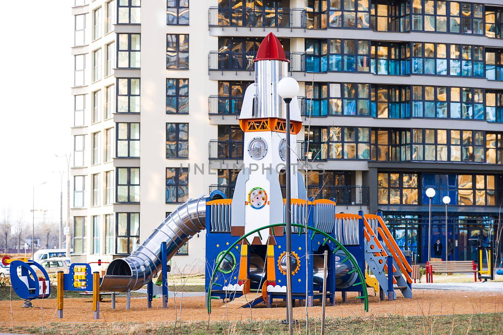 Children's town, playground, equipment for entertainment and sports. Modern entertainment for children in the big city. Urban landscape, high-rise building, modern city.