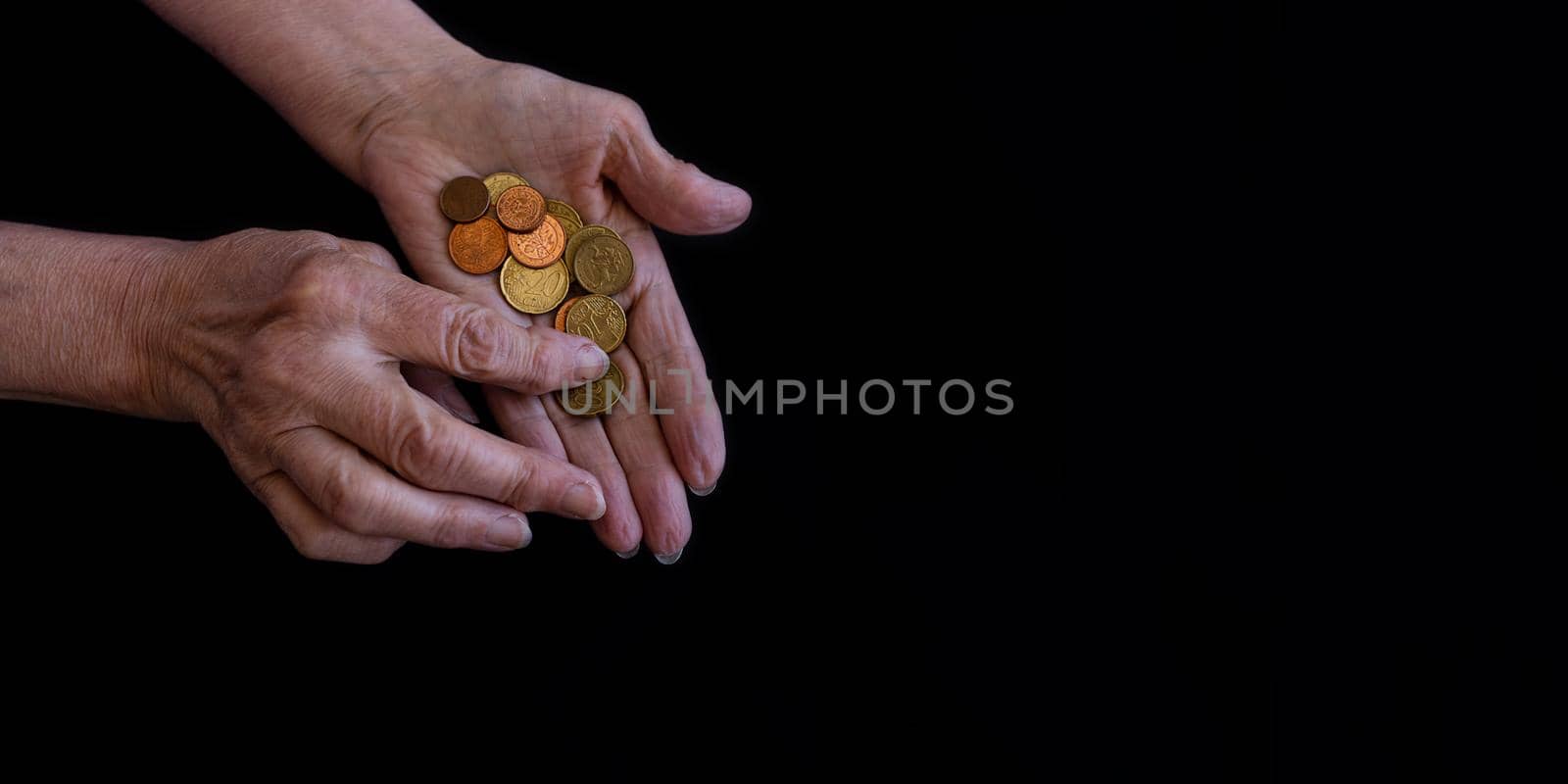 Women's hands close-up counting coins in the palms. Copy paste, black background by Ramanouskaya