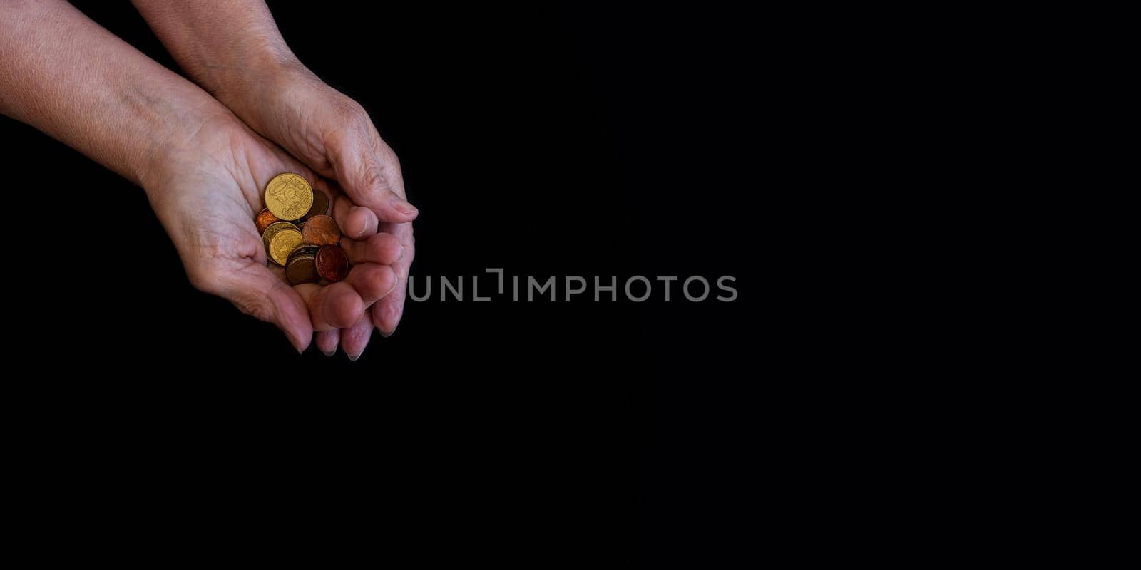 The hands of a white old woman, wrinkled and arthritic, hold the last coins. The concept of poor people, third world countries, expensive food, old age. Currency, rising oil and gas prices