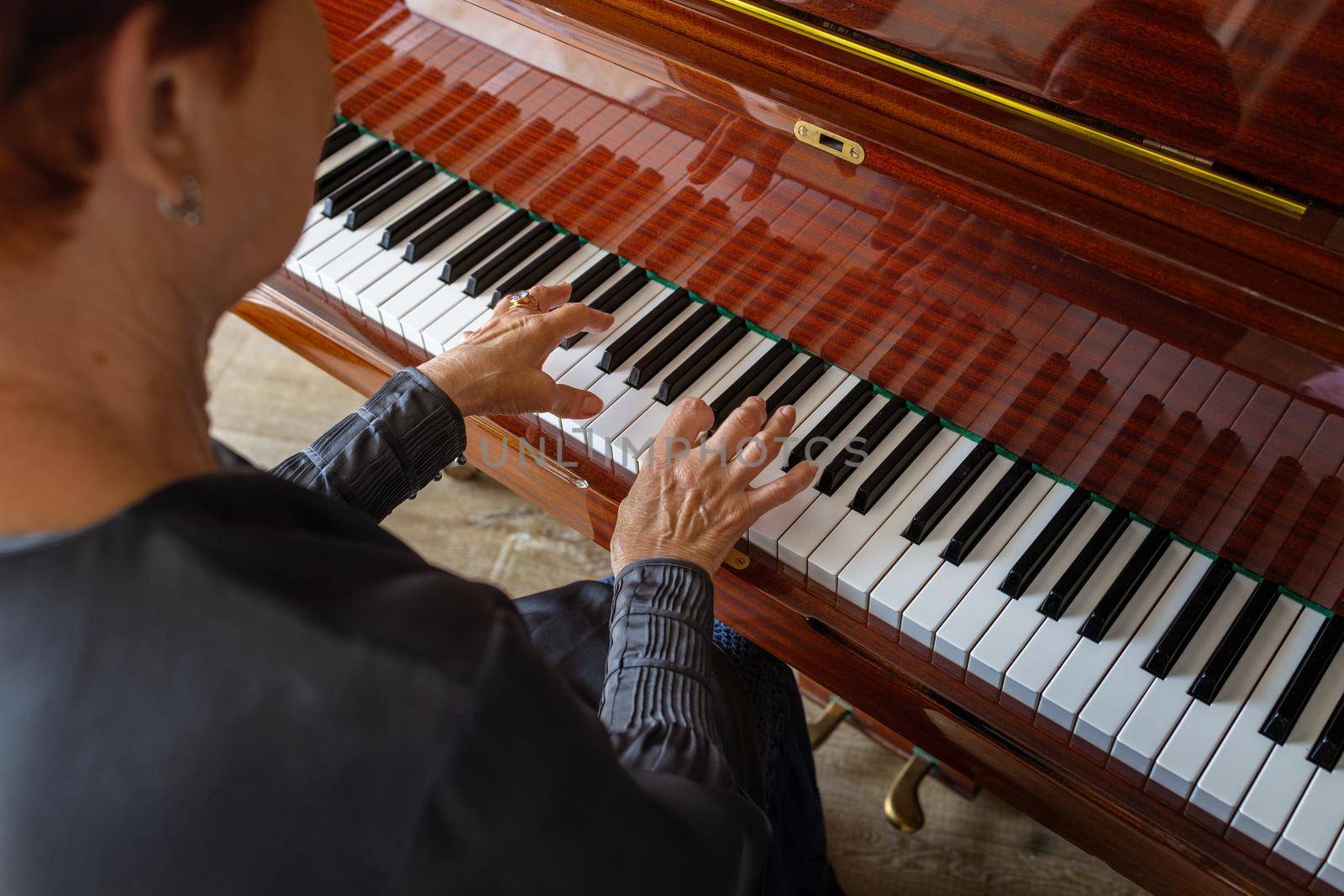 Old music teacher playing the piano by Ramanouskaya